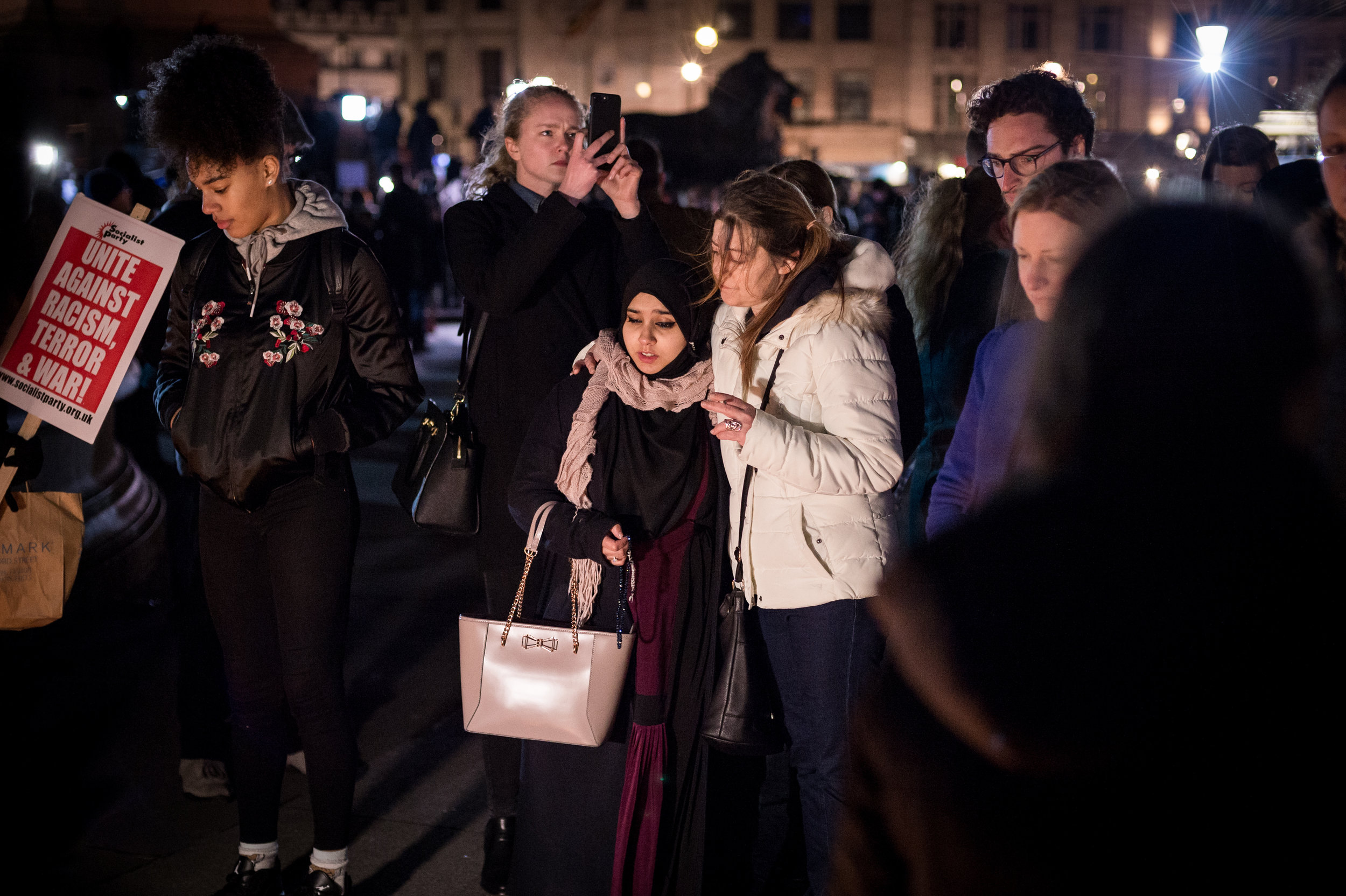  A visibly distressed Muslim woman is comforted by a friend.&nbsp; 