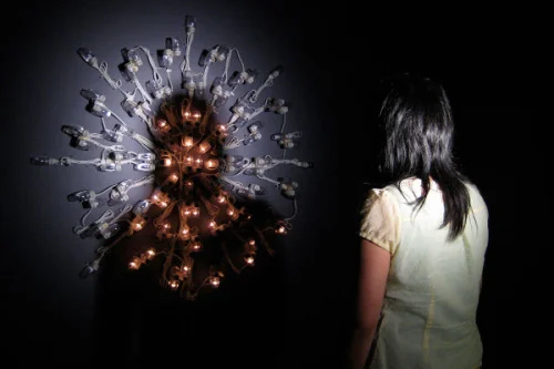 Image: Dark into Light, 2008, mixed media installation: 100 night lights, par can, spot bulb, interaction view