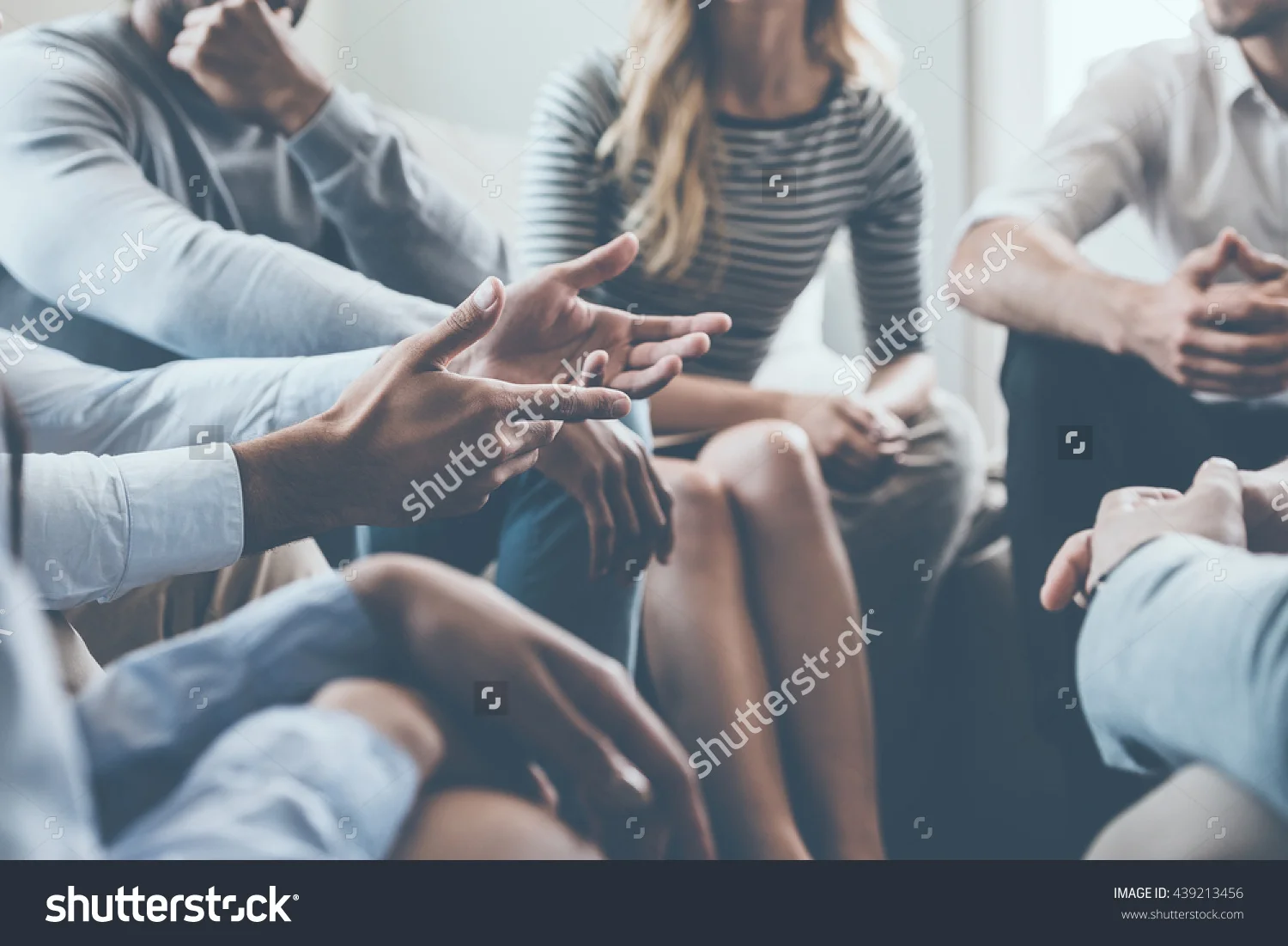 stock-photo-close-up-on-discussion-close-up-of-people-communicating-while-sitting-in-circle-and-gesturing-439213456.jpg