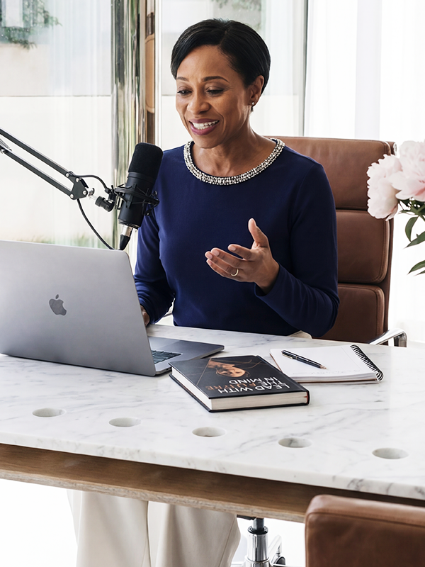 Female UK business expert speaking into a microphone during a professional corporate podcast guest placement interview.