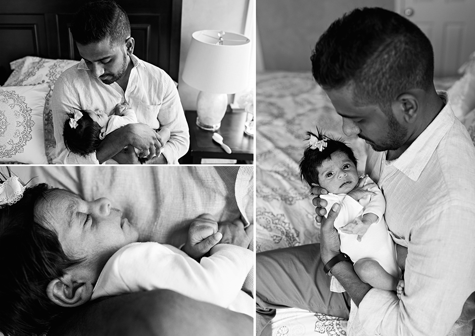 dad holding newborn daughter on bed southington connecticut newborn photographer