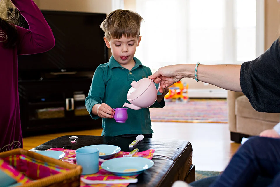 mom pours tea at tea party for son west hartford ct documentary family photography