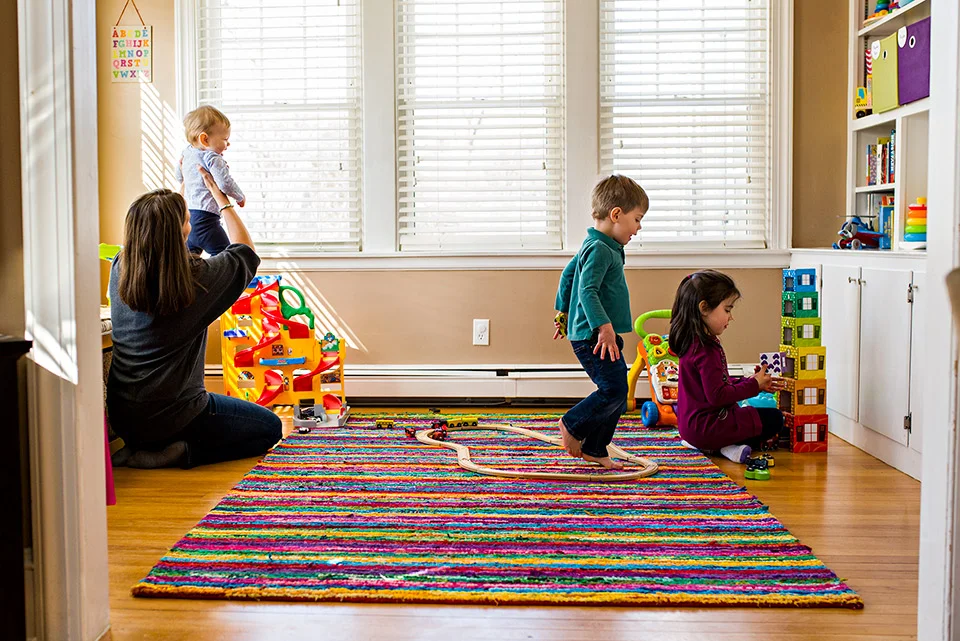 mom and children playing in their playroom with toys west hartford ct family documentary photography