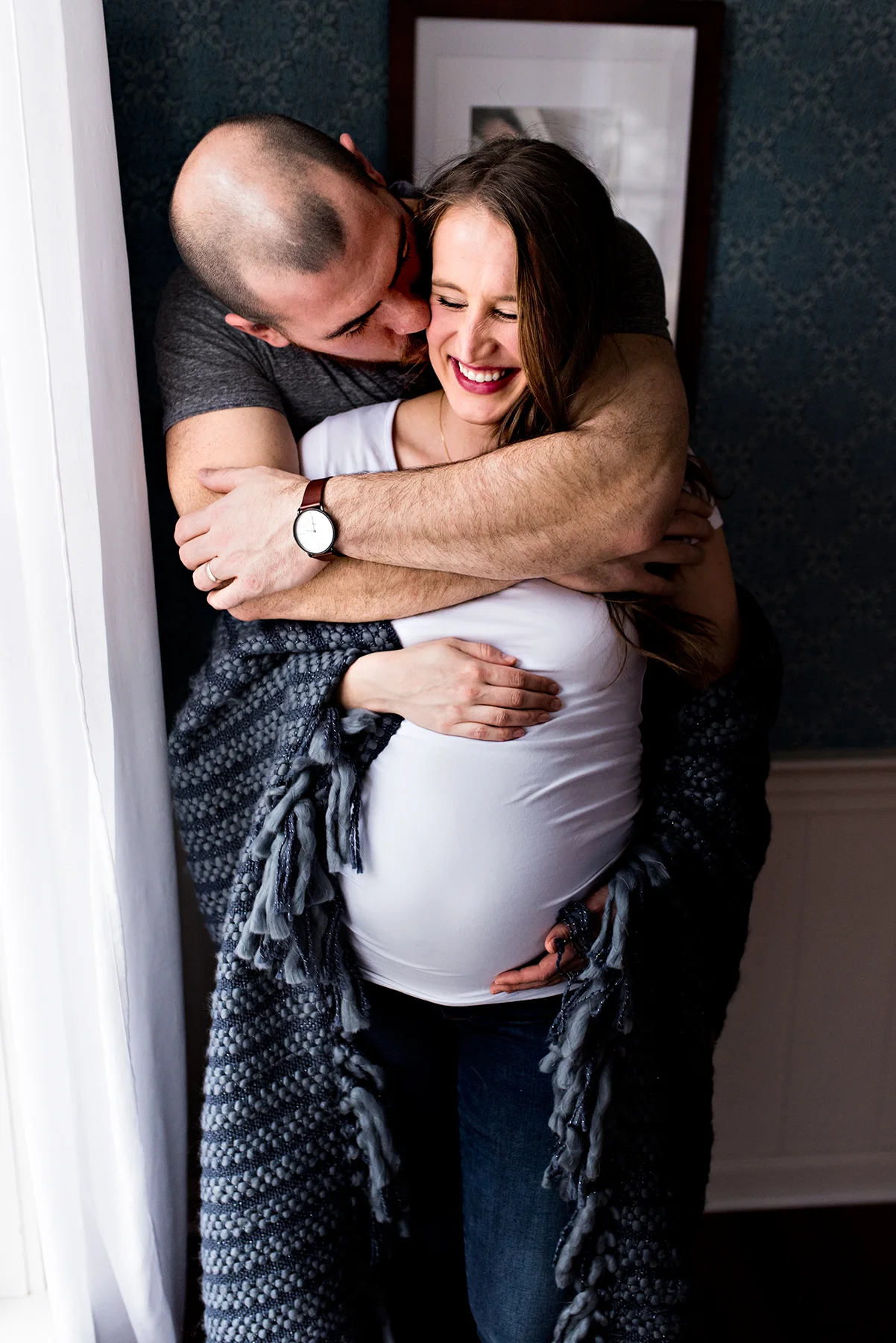 husband hugging pregnant wife in living room burlington connecticut maternity photography 