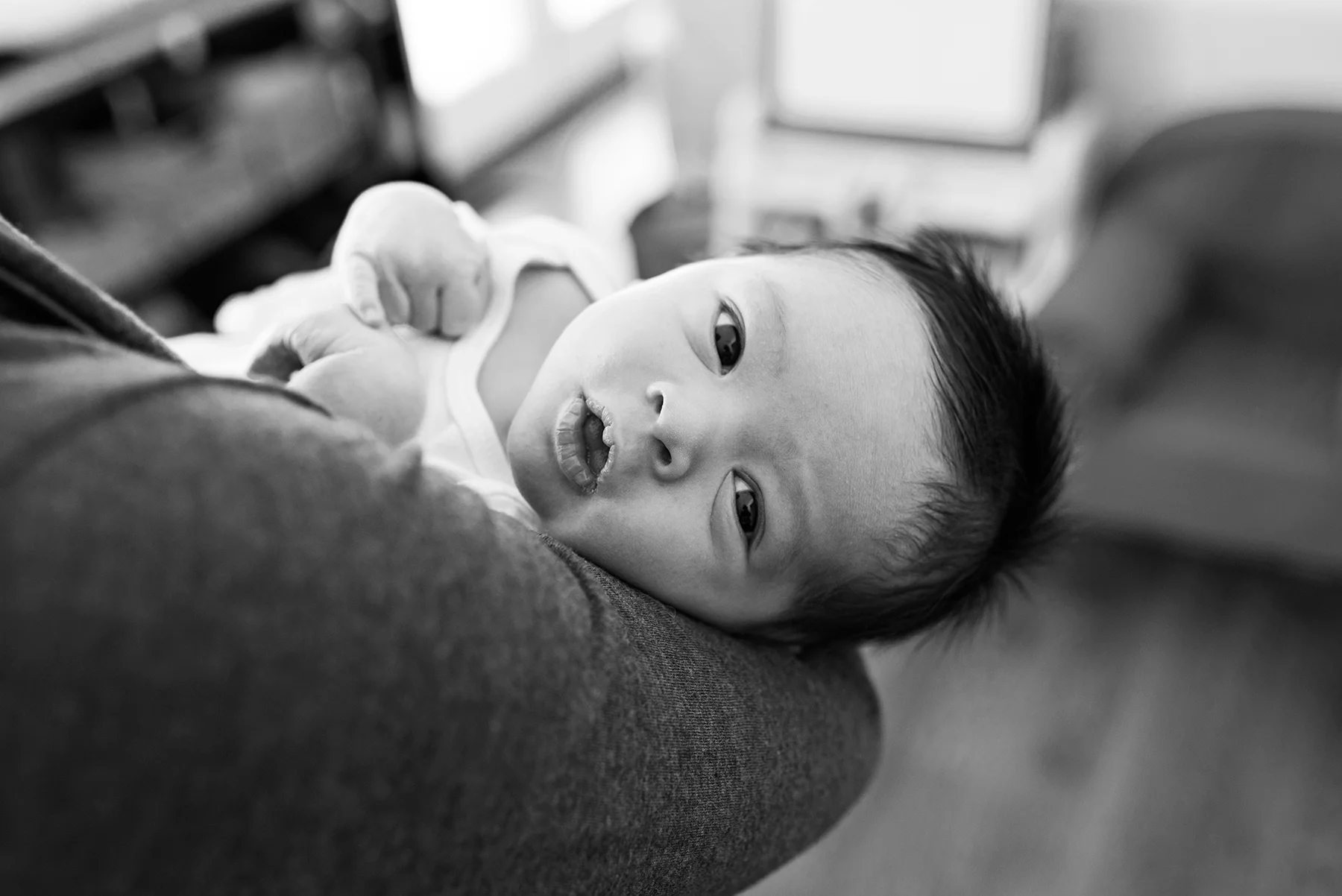 newborn baby boy in moms arms at middletown connecticut lifestyle newborn photography