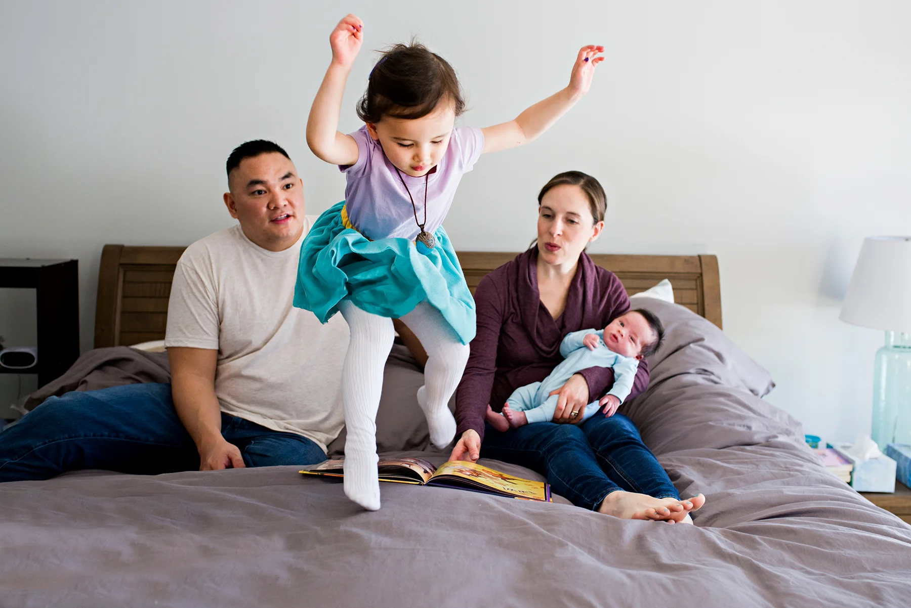 girl jumping on bed at lifestyle newborn photography middletown ct