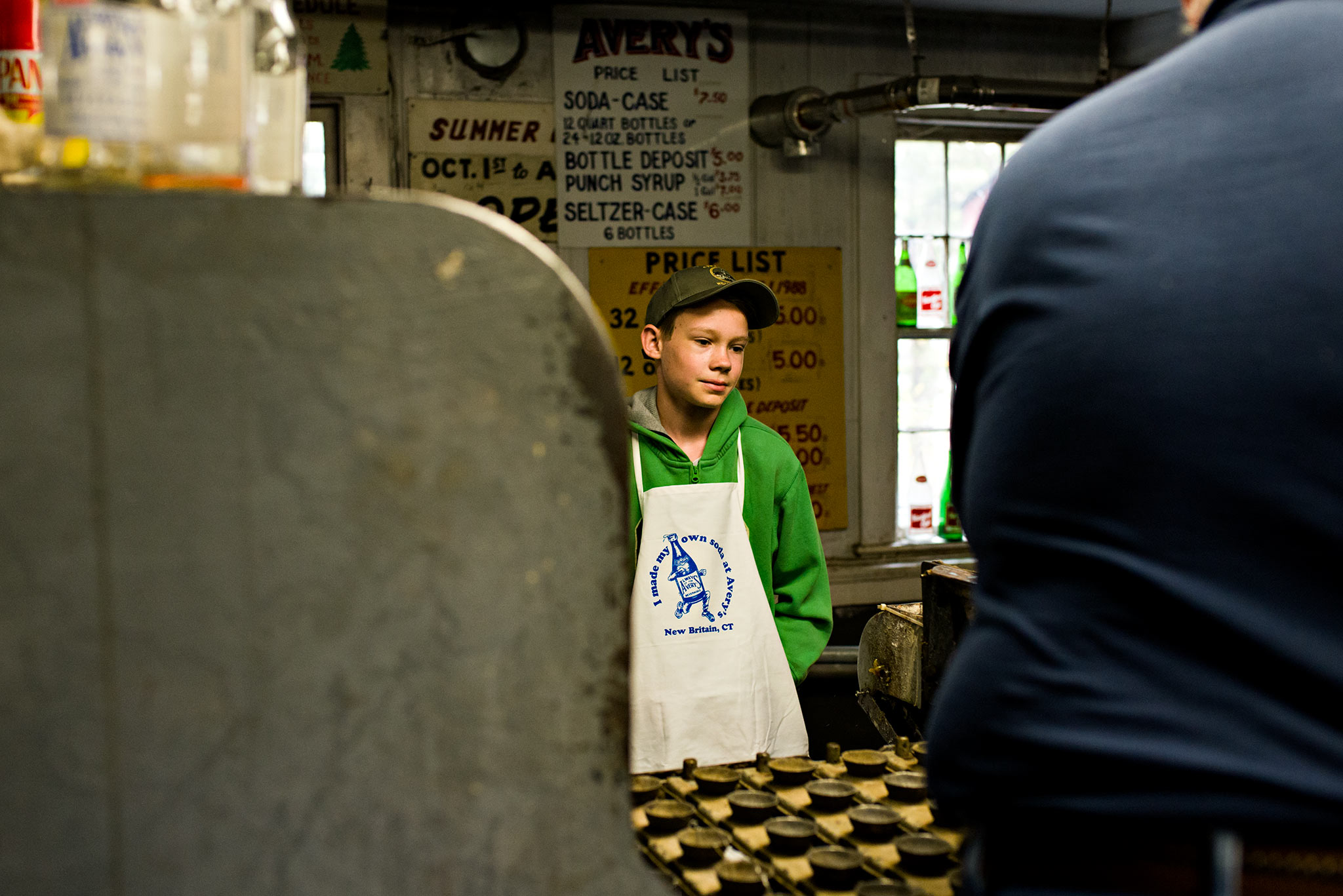 boy watching soda bottles get washed at averys soda new britain connecticut lifestyle photography