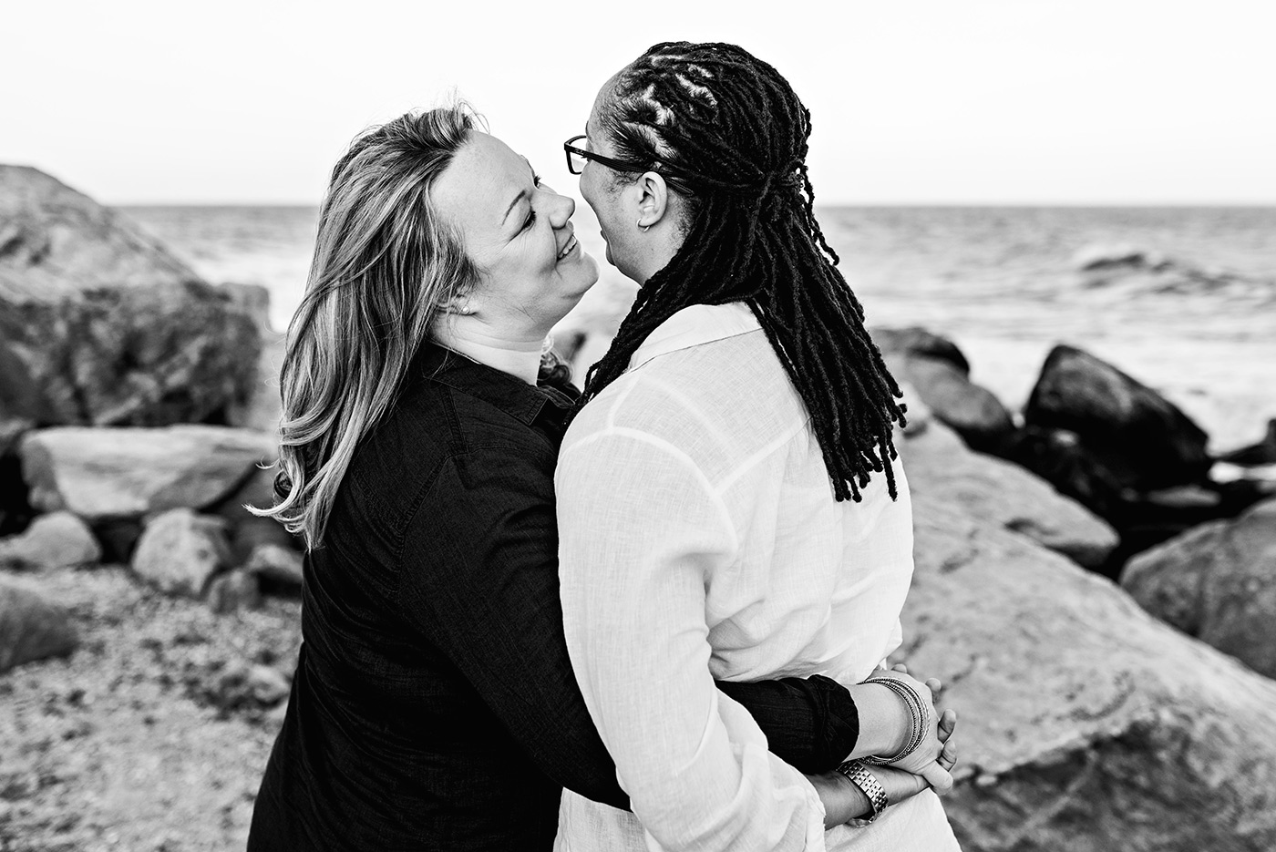 two women hugging at hammonasset beach connecticut wedding photographer