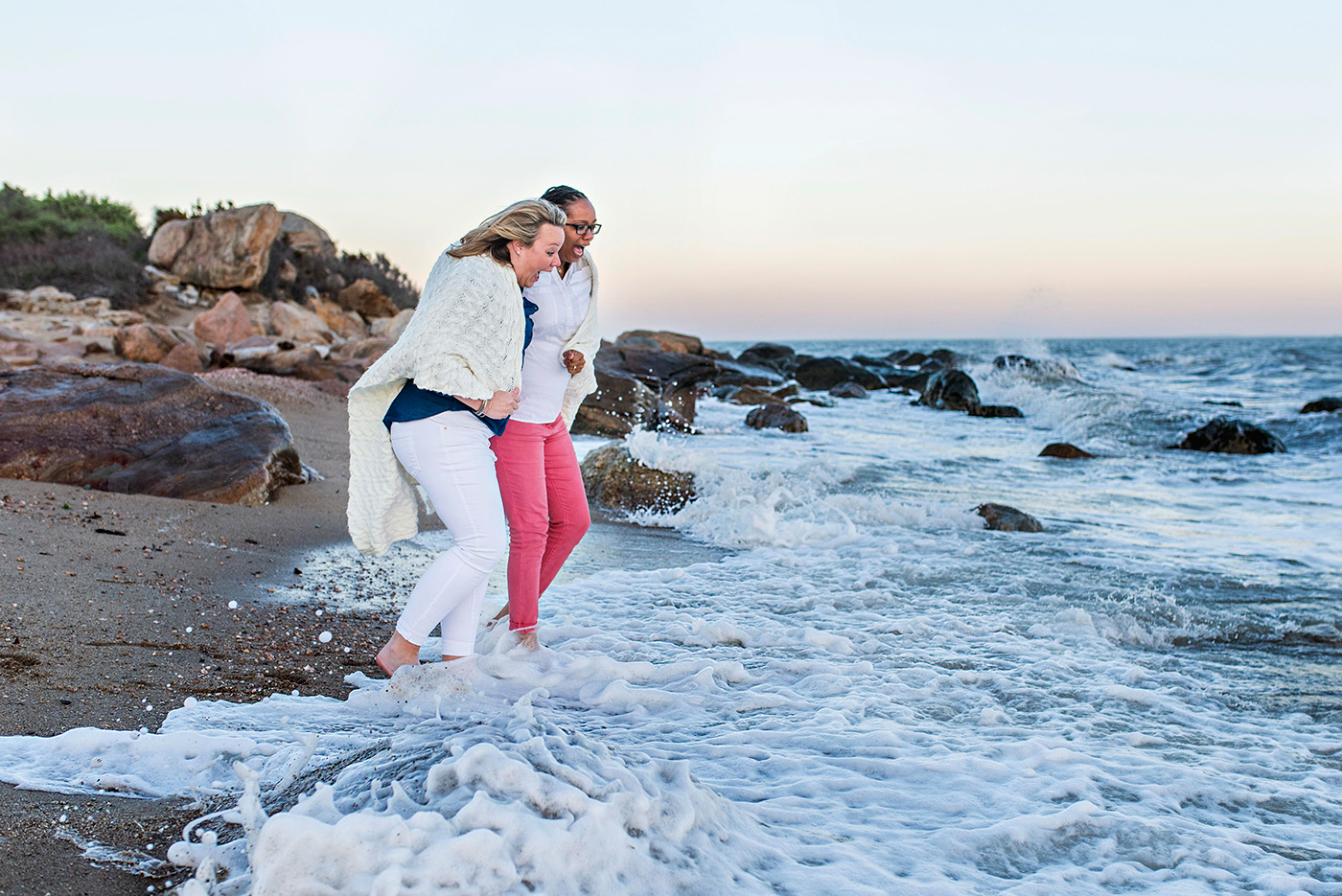 two women running into water at hammonasset beach connecticut wedding photographer 