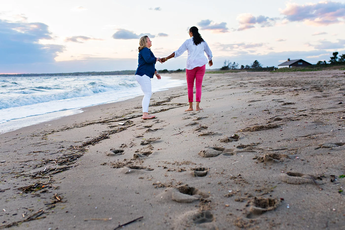 women dancing on beach at sunset madison connecticut wedding photographer