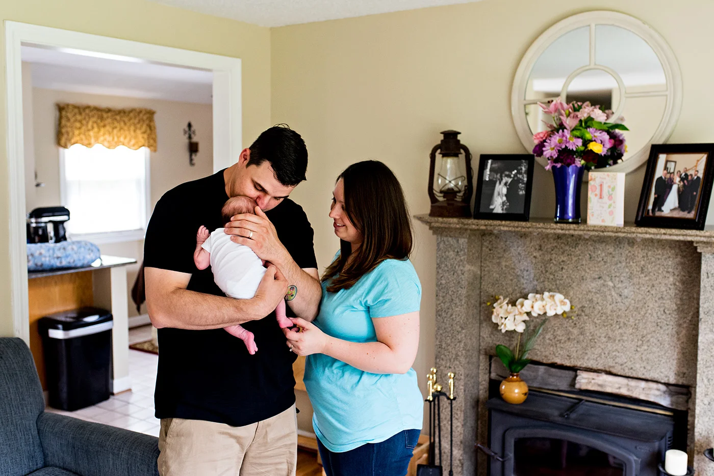 dad kissing newborn in living room southington ct newborn photography