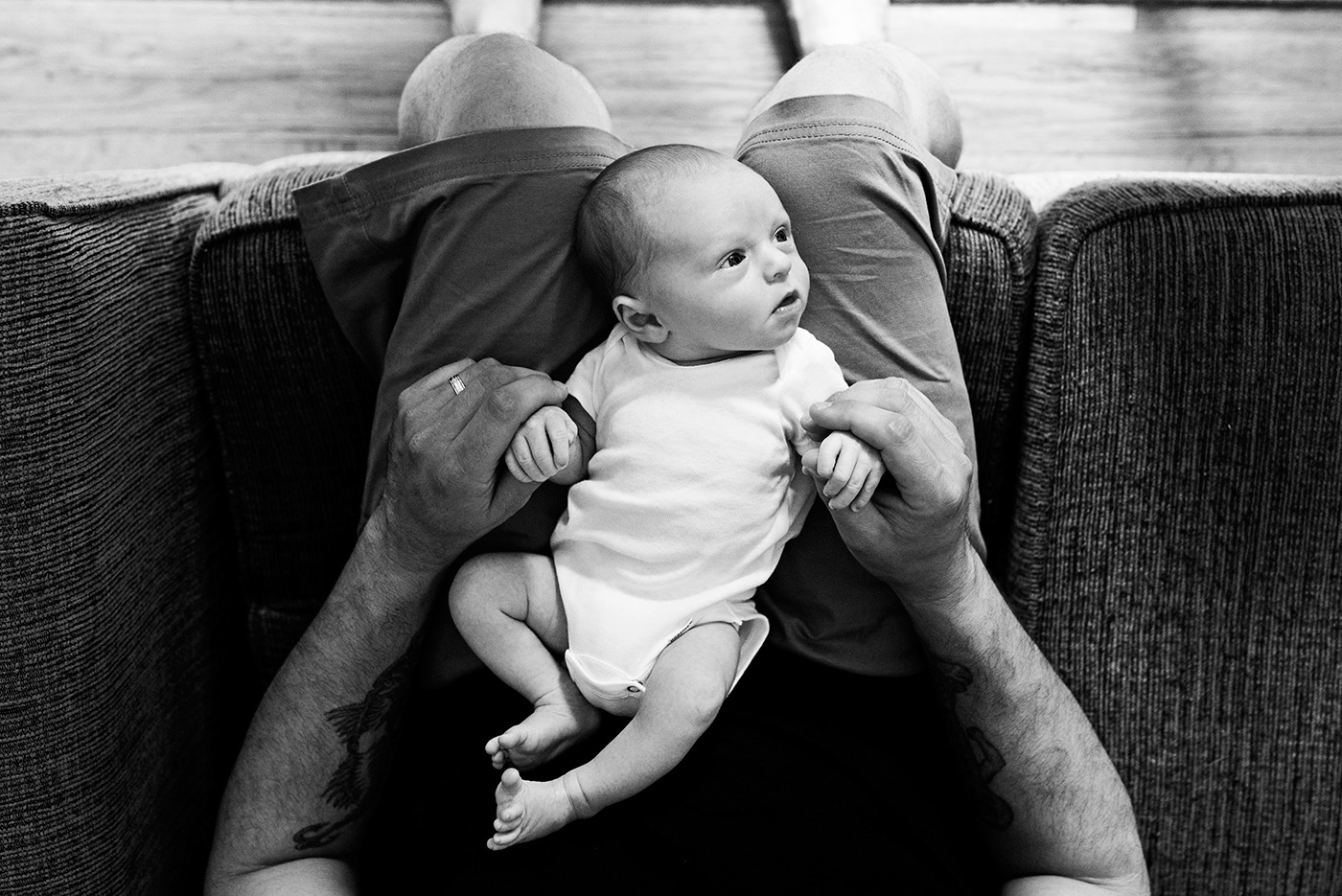 newborn son in dads lap holding hands southington ct newborn photography