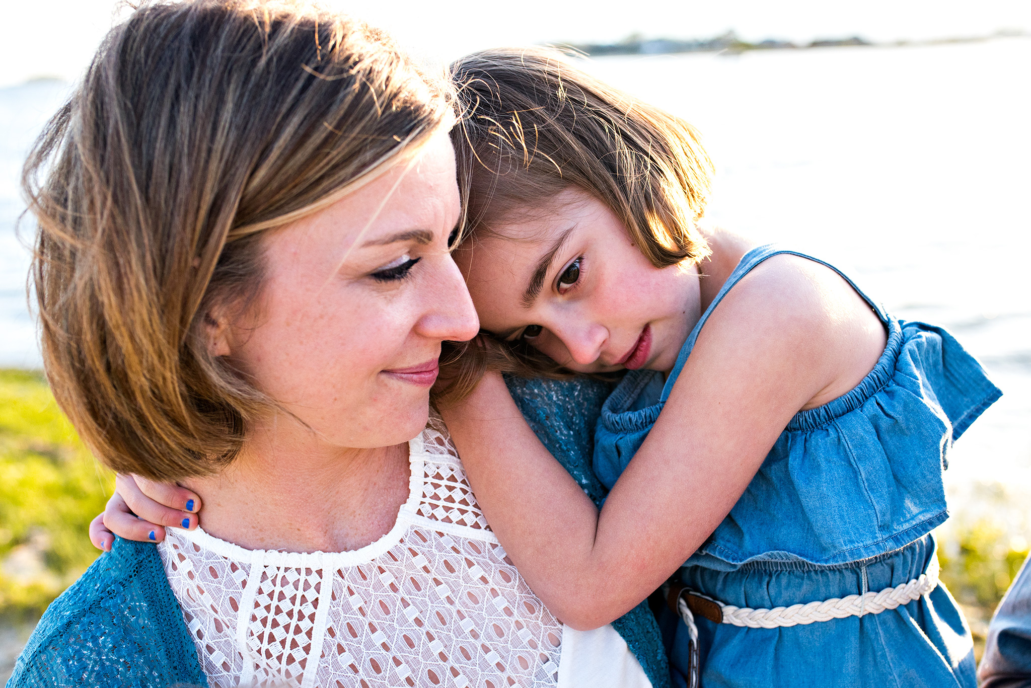 mom snuggling daughter during family photography ct clinton beach