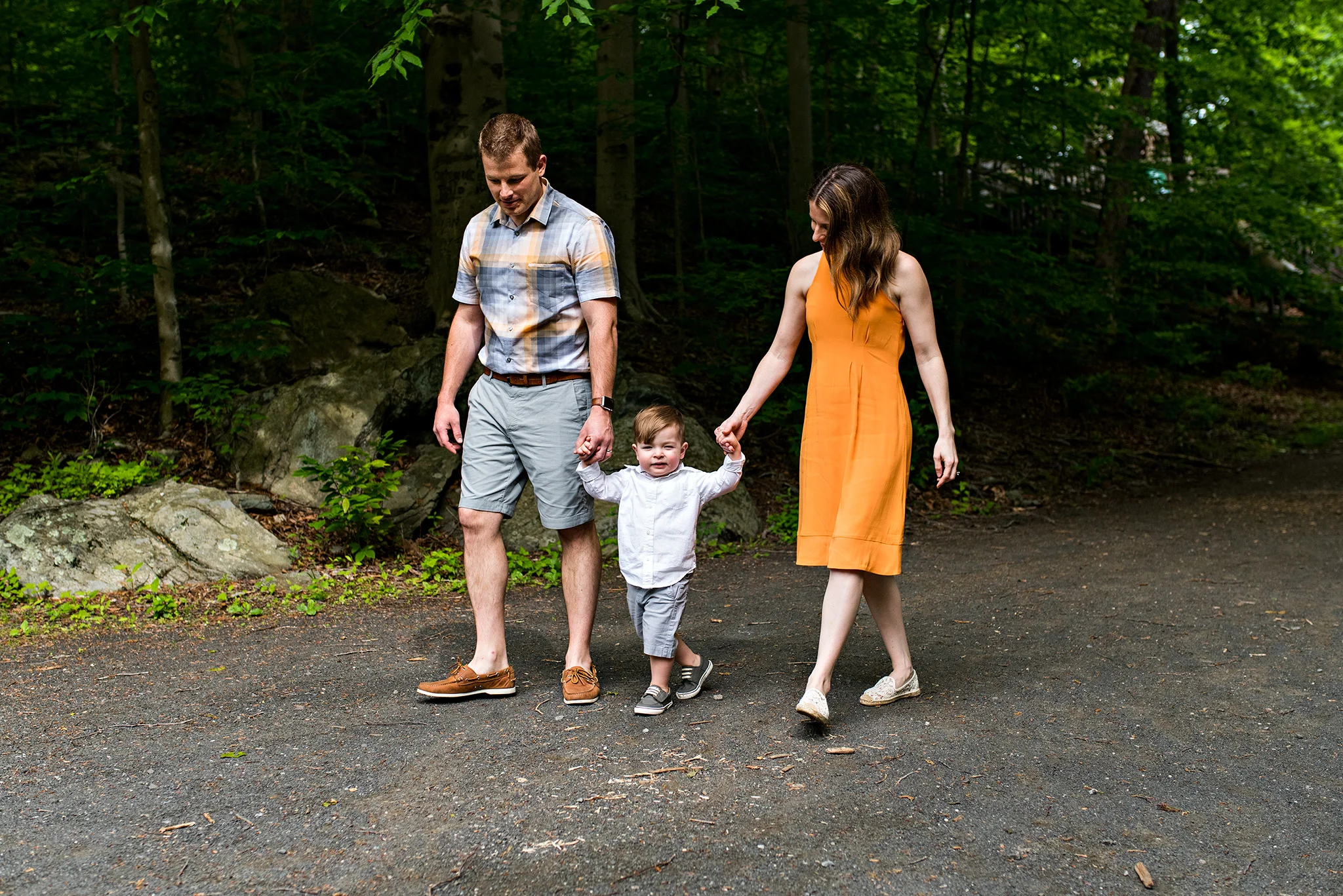 parents holding hands with son stamford, ct nature center conneticut photography
