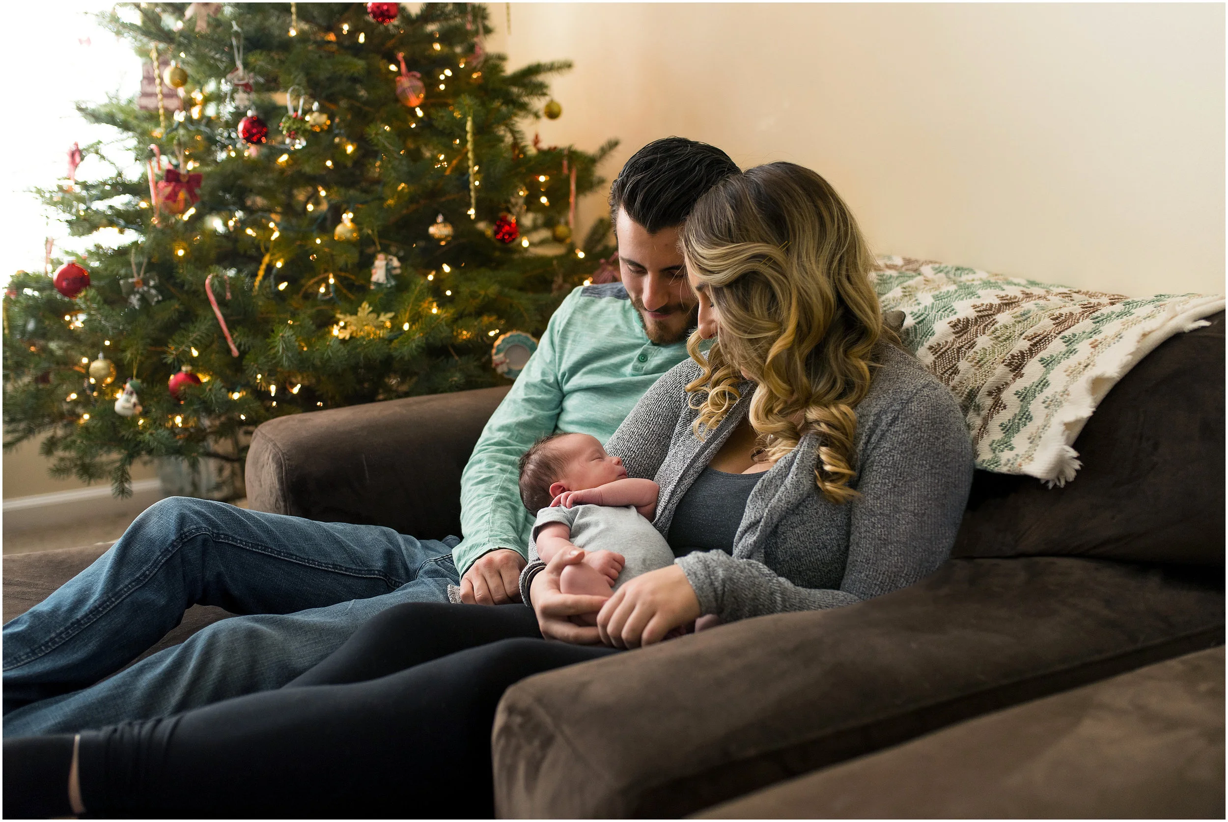 mom and dad snuggling newborn during newborn photography connecticut 
