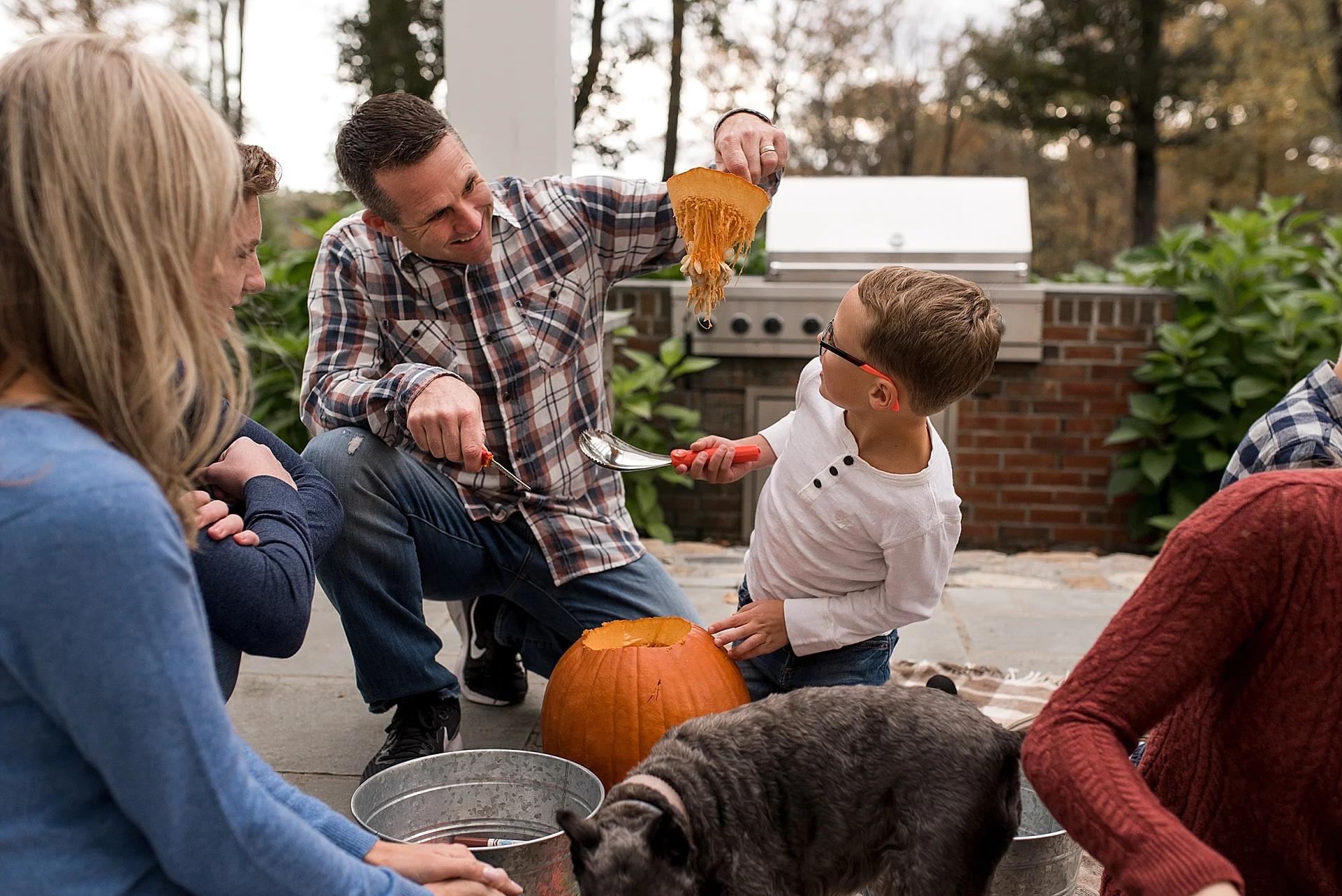 father and son carving pumpkins. New Hartford, Connecticut family photographer.