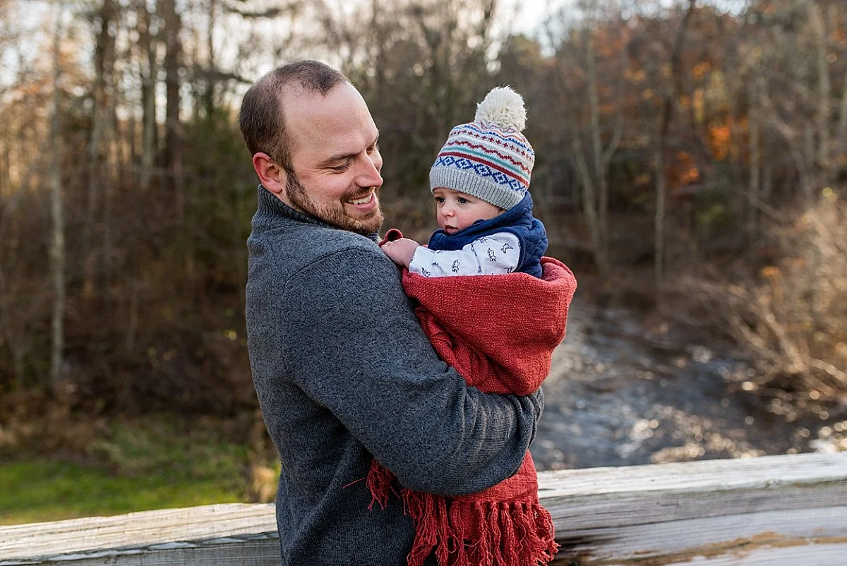 Dad smiling at is son during a CT family photography session in the Winter.