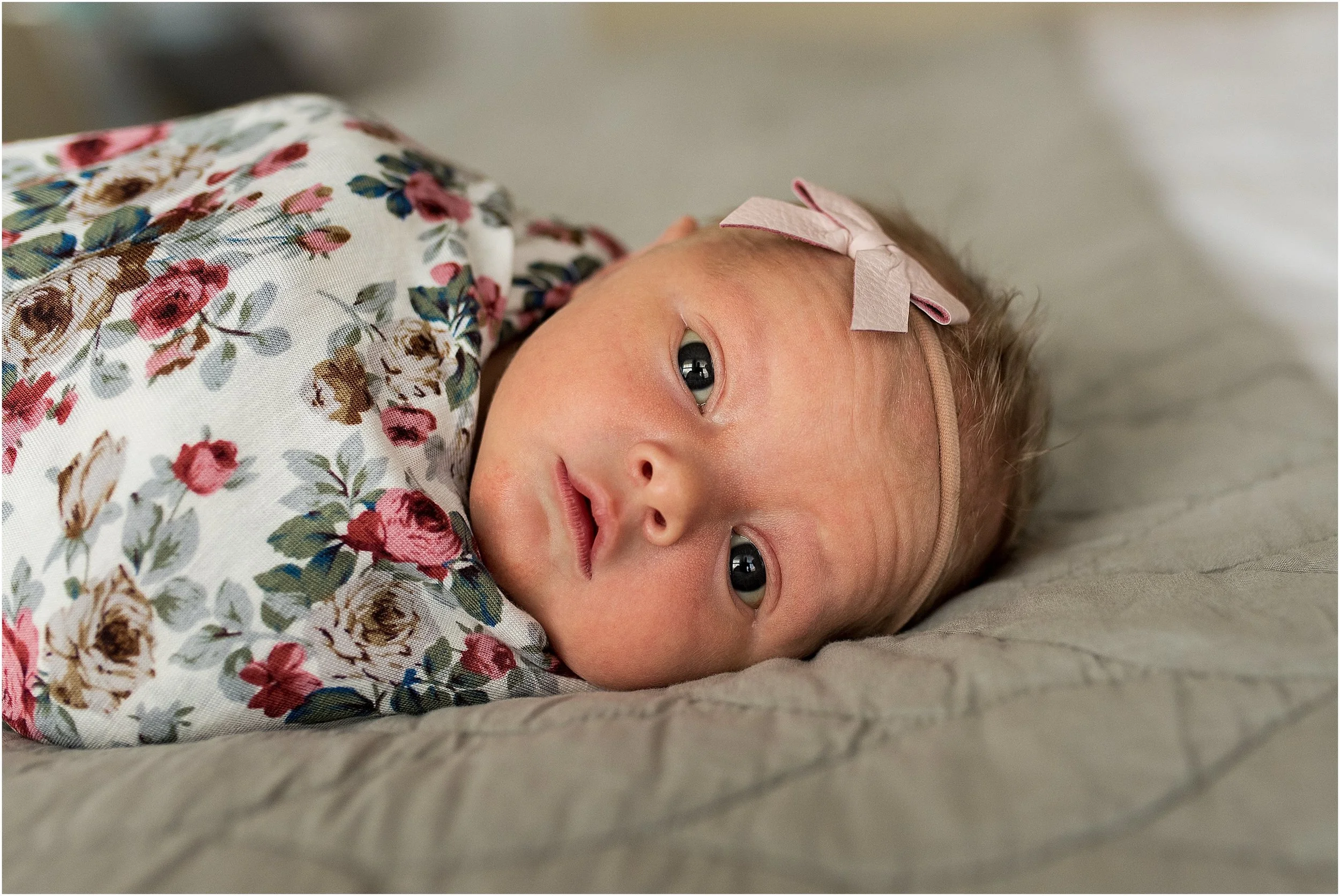 Connecticut newborn in floral swaddled with headband.