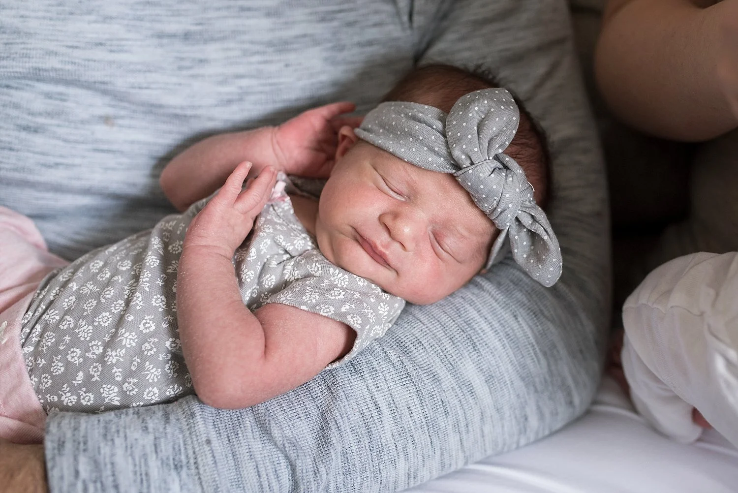 infant girl with grey headband during ct newborn photography session.