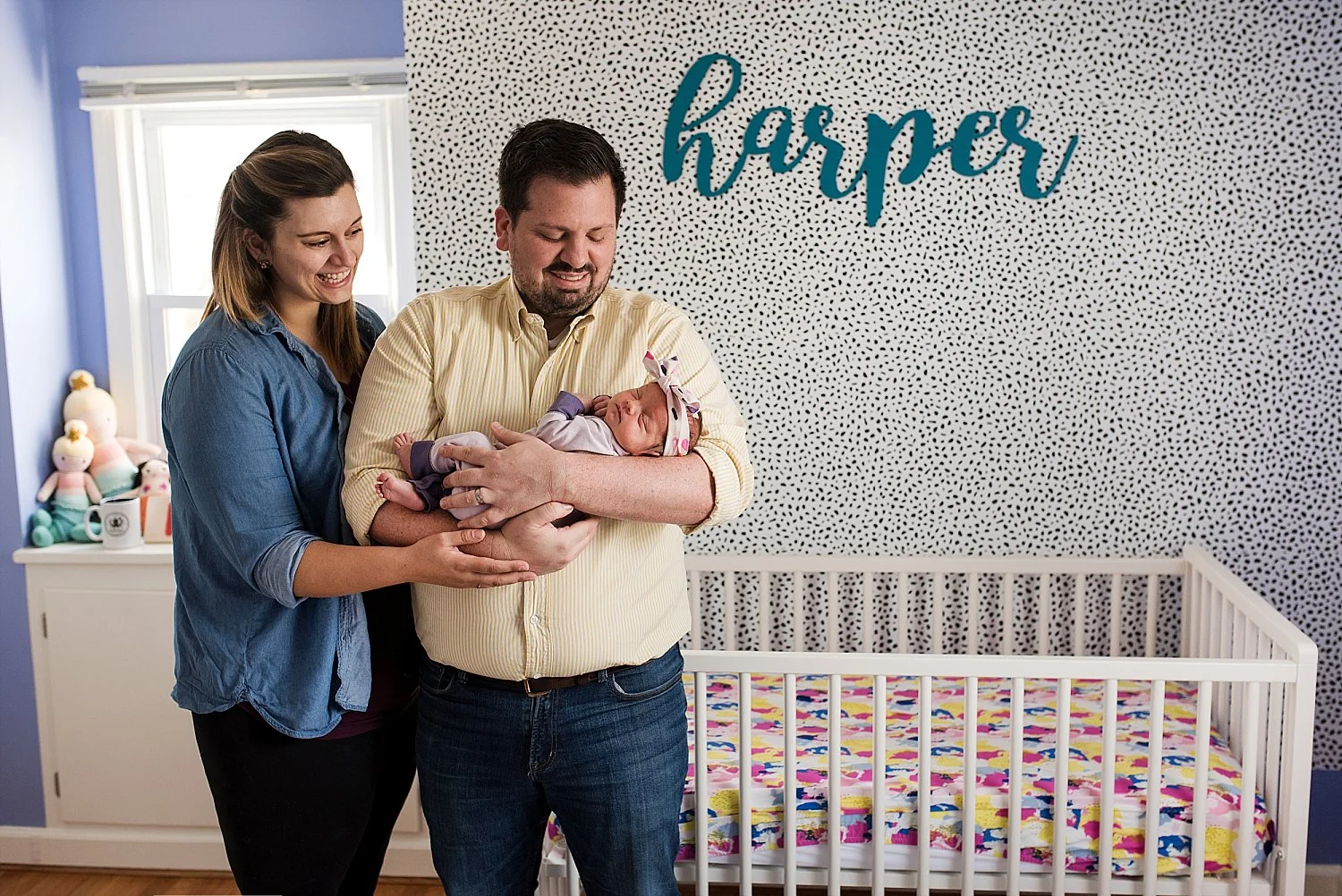 New parents in their baby’s nursery during their lifestyle newborn photography ct