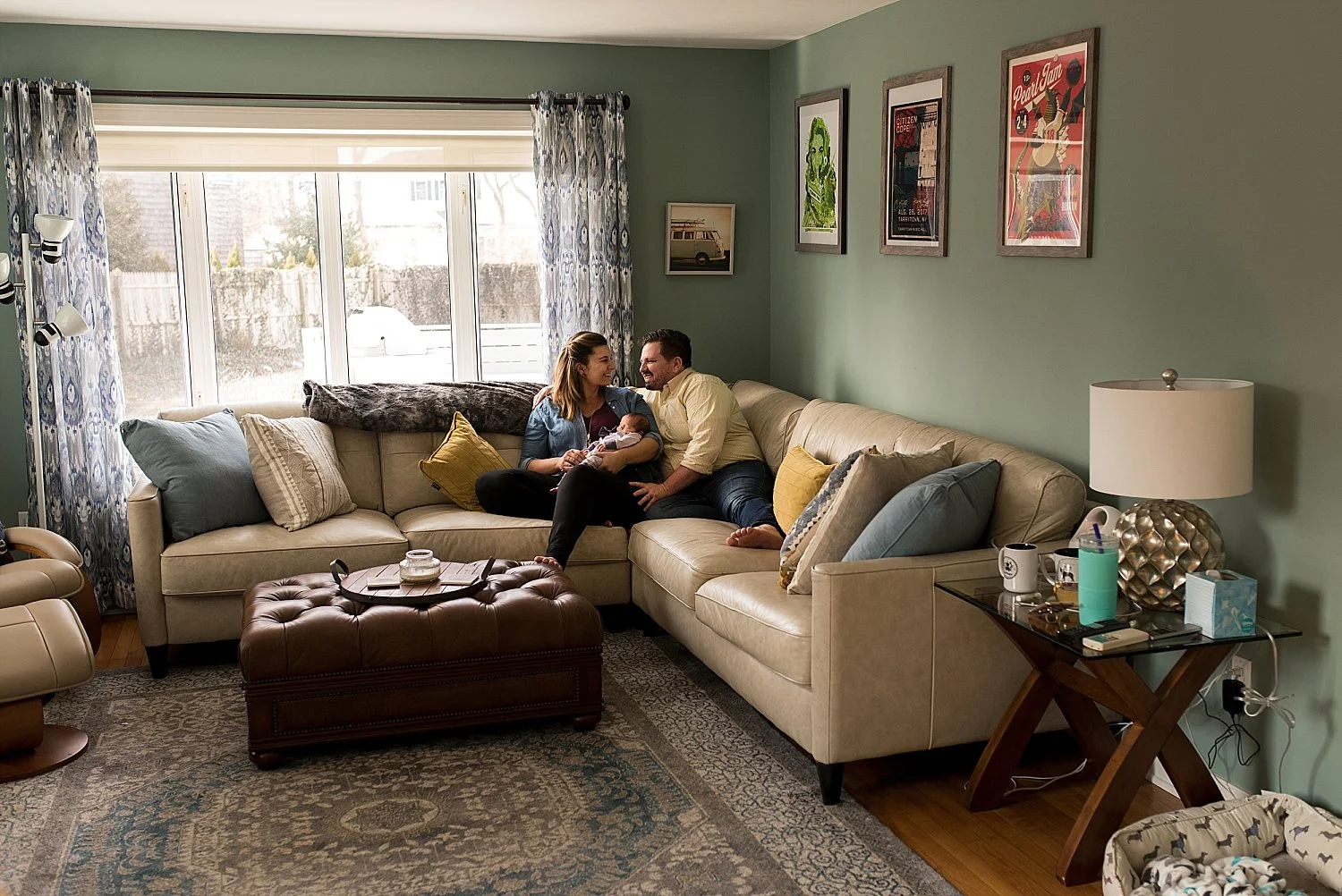 Mom and Dad posing on couch during connecticut newborn photo session
