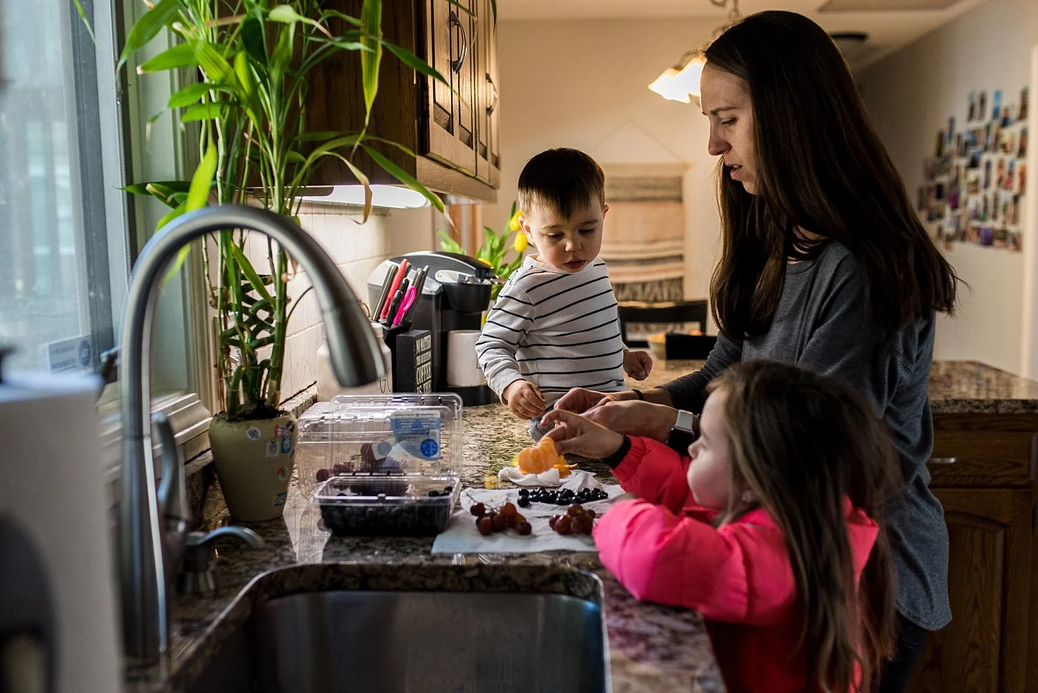 children helping mom wash fruits for a snack. Connecticut children photography.