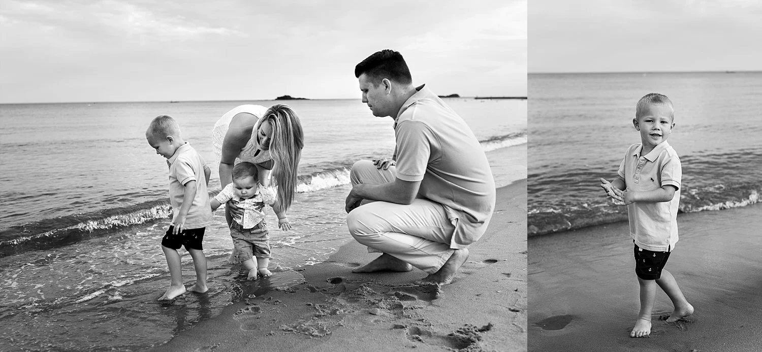 Connecticut family photographer. Mom and Dad playing in the ocean with children during Westbrook, CT photography