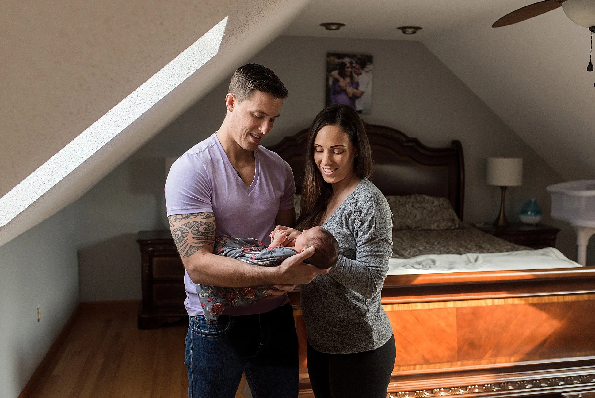 New mom and dad snuggling their newborn daughter. Maternity and newborn photography packages.
