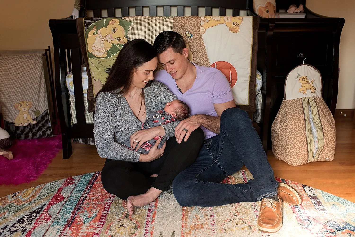 new mom and dad holding infant daughter in nursery during CT newborn photography