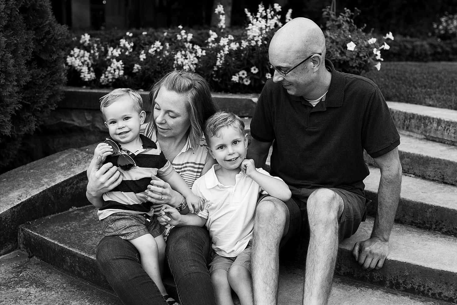 mom and dad sitting with children on steps in waterford, ct during Connecticut family photography