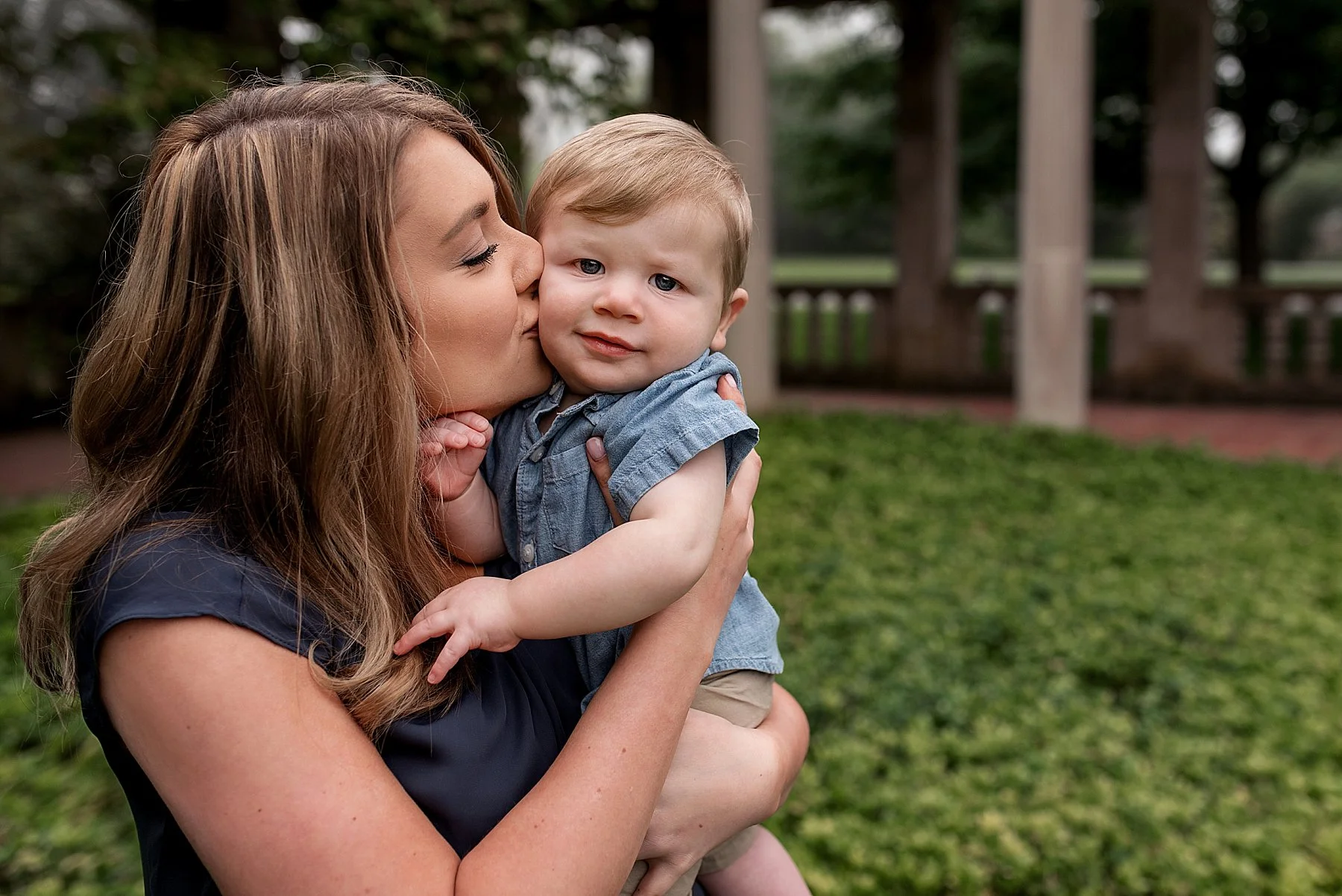 Connecticut family photographer. Mother kissing infant’s cheek