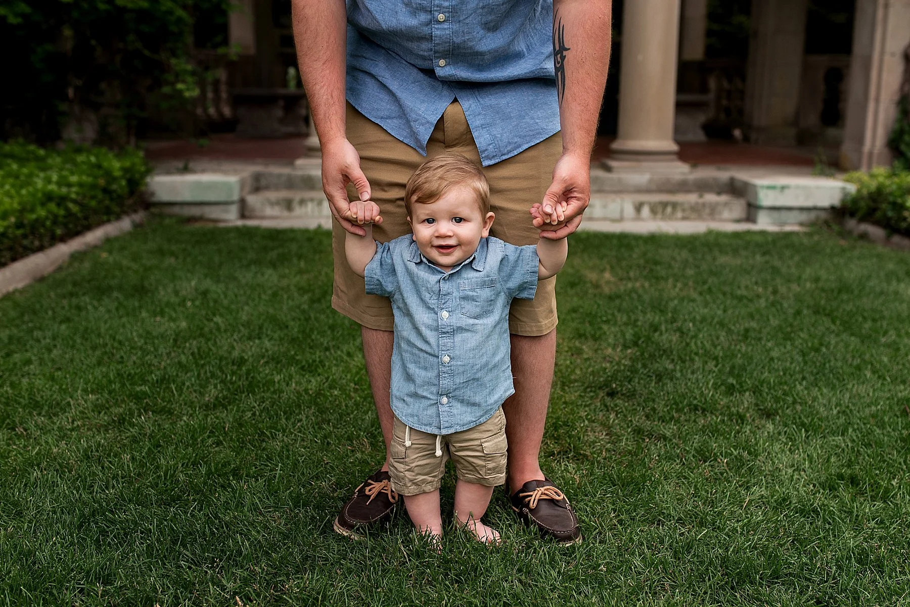 Baby holding dad’s hands at CT family photo session