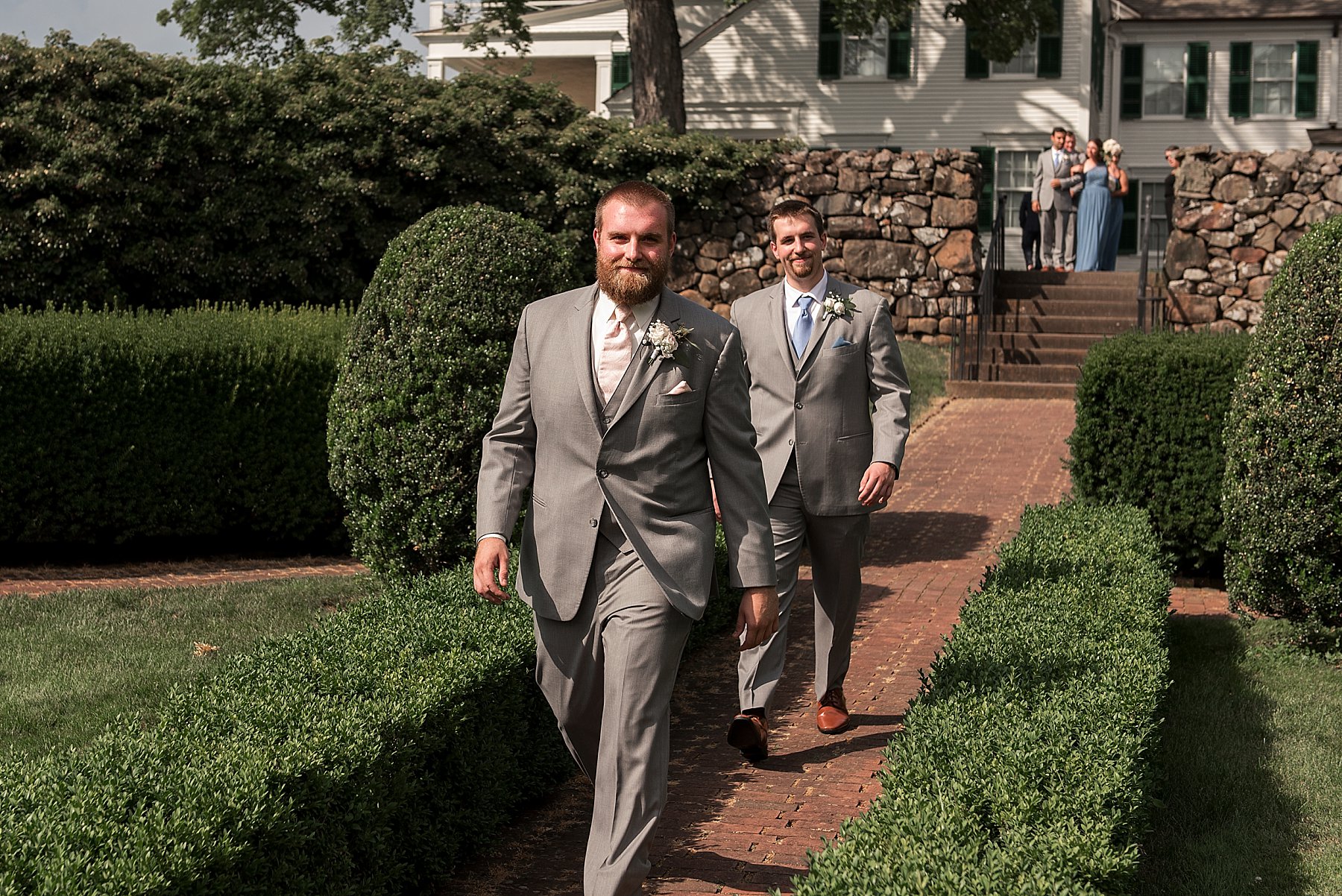 Groom walking down the isle on a sunny wedding day