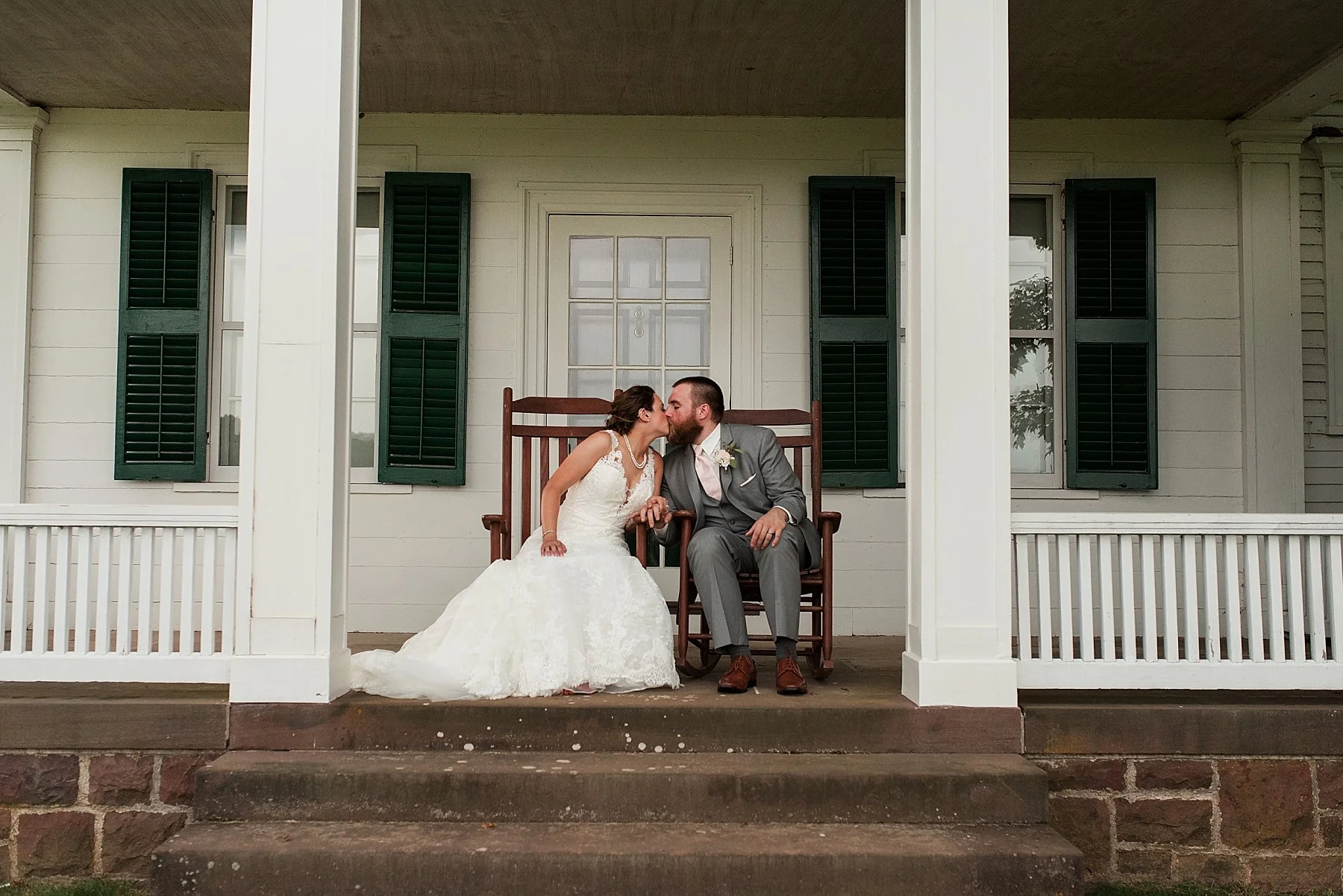 bride and groom sitting on porch at hillstead museum venue