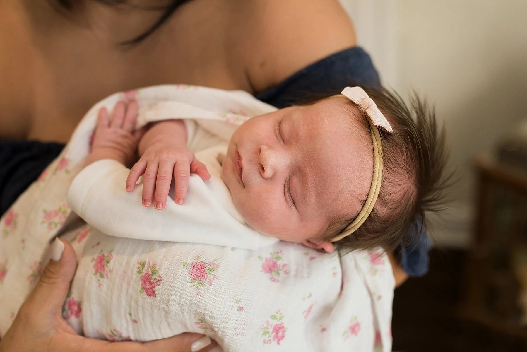 baby girl sleeping in Moms arms during connecticut newborn photo session
