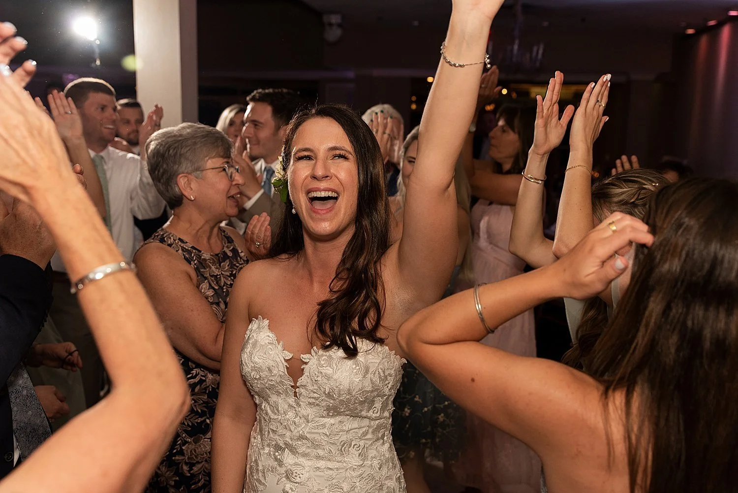 bride dancing in a a crowd of guests at wedding day on Connecticut shoreline Anthonys Ocean View