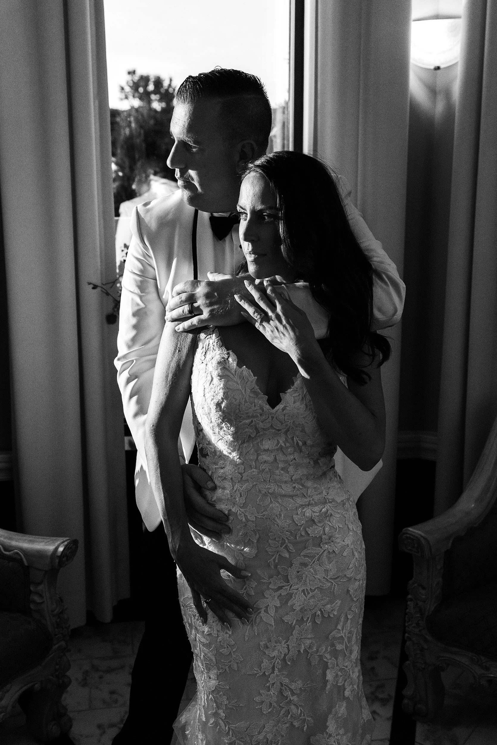 dramatic black and white portrait in harsh directional light of bride and groom on wedding day in Southington, CT