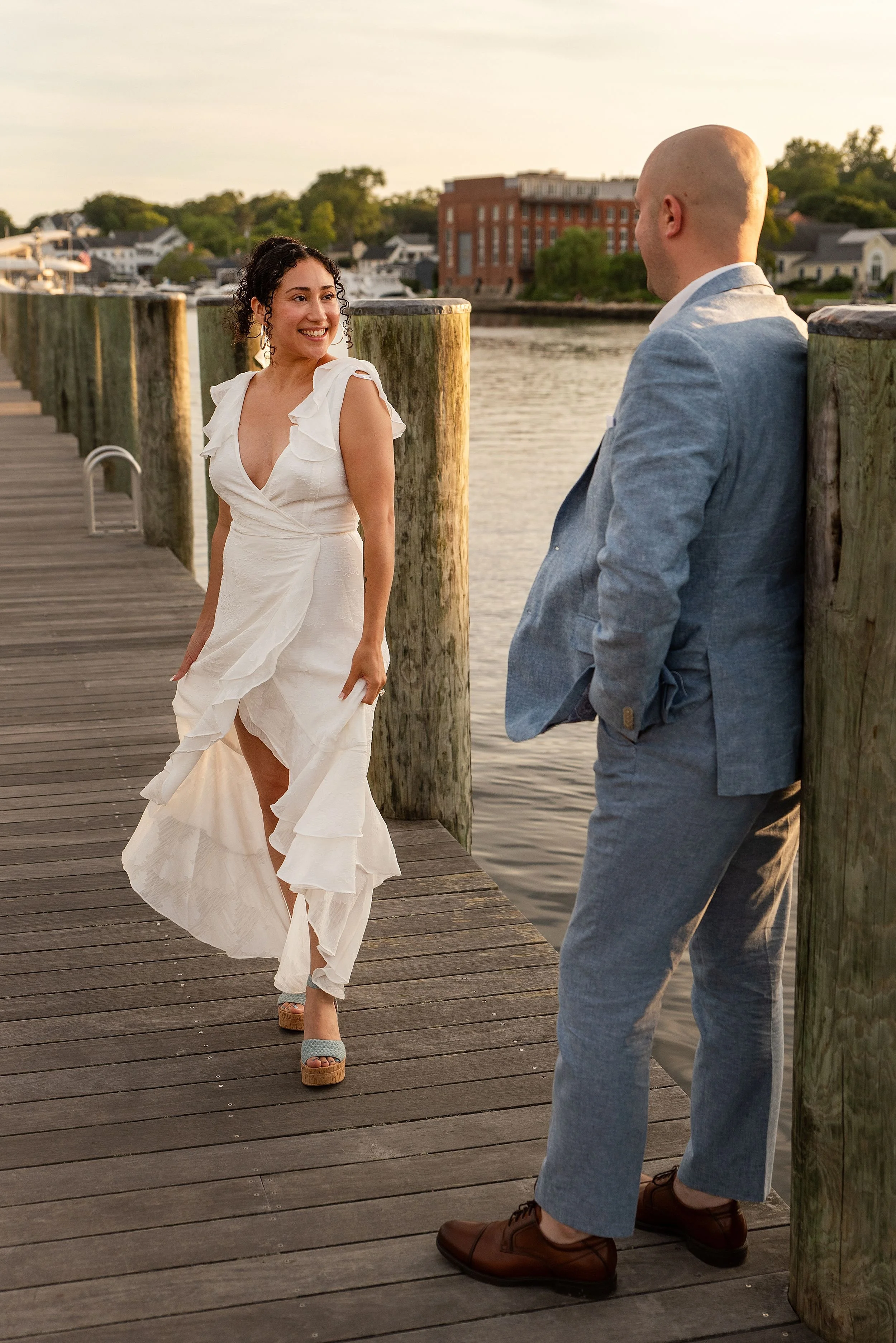 Connecticut cinematic wedding and elopement photographer Rebecca Lynne photographs bride and groom on pier on the coast of CT