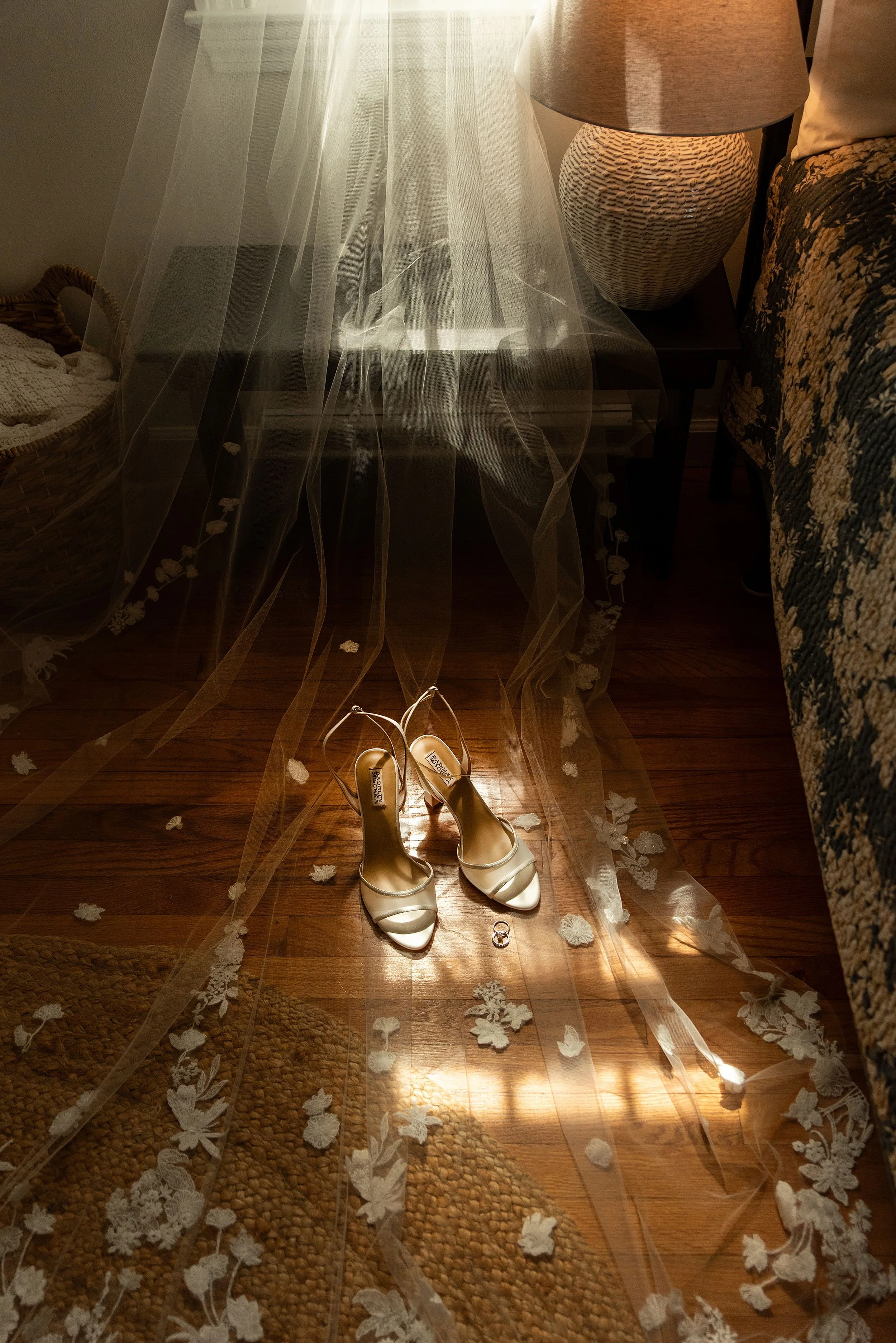 brides wedding shoes with veil and rings in moody window light of childhood home getting ready space Clinton, CT