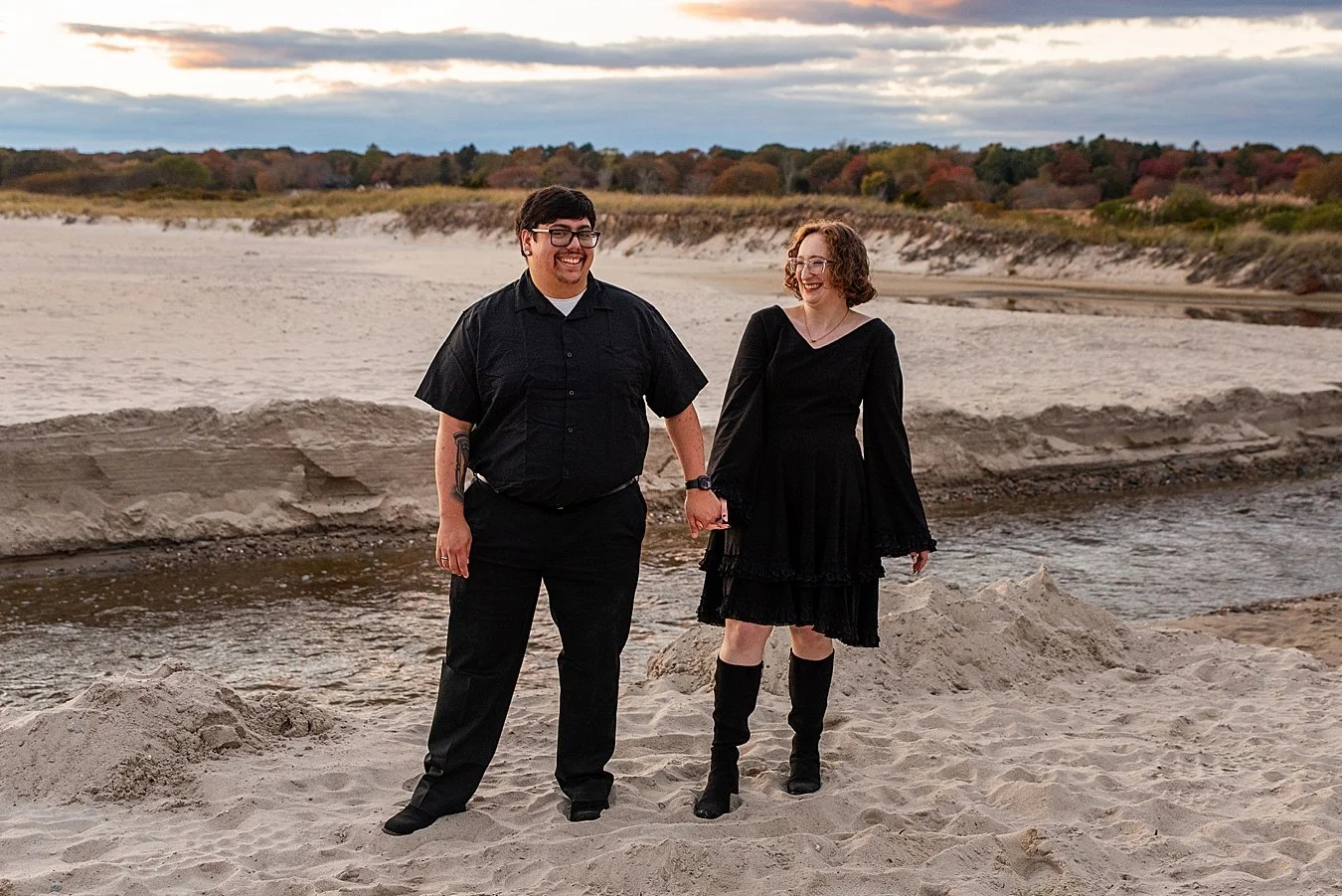 couple holding hands on the beach during engagement photo session