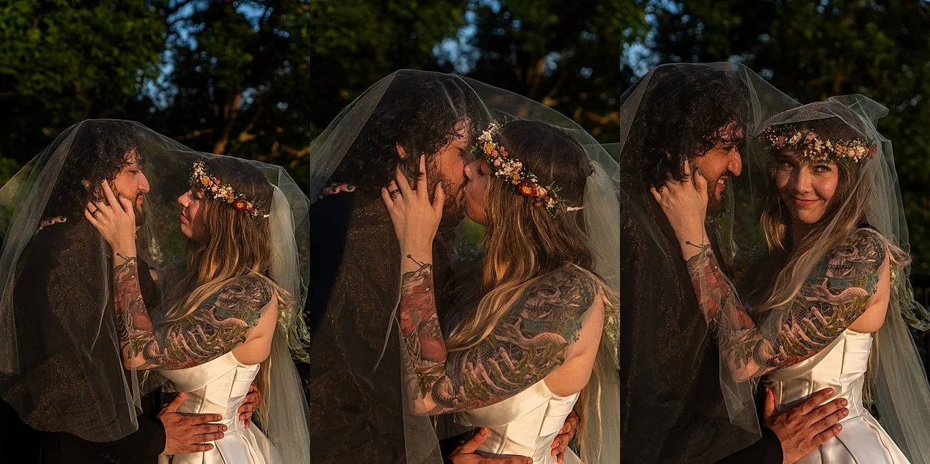 sun drenched elopement photography of bride and groom under veil after woodland wedding ceremony