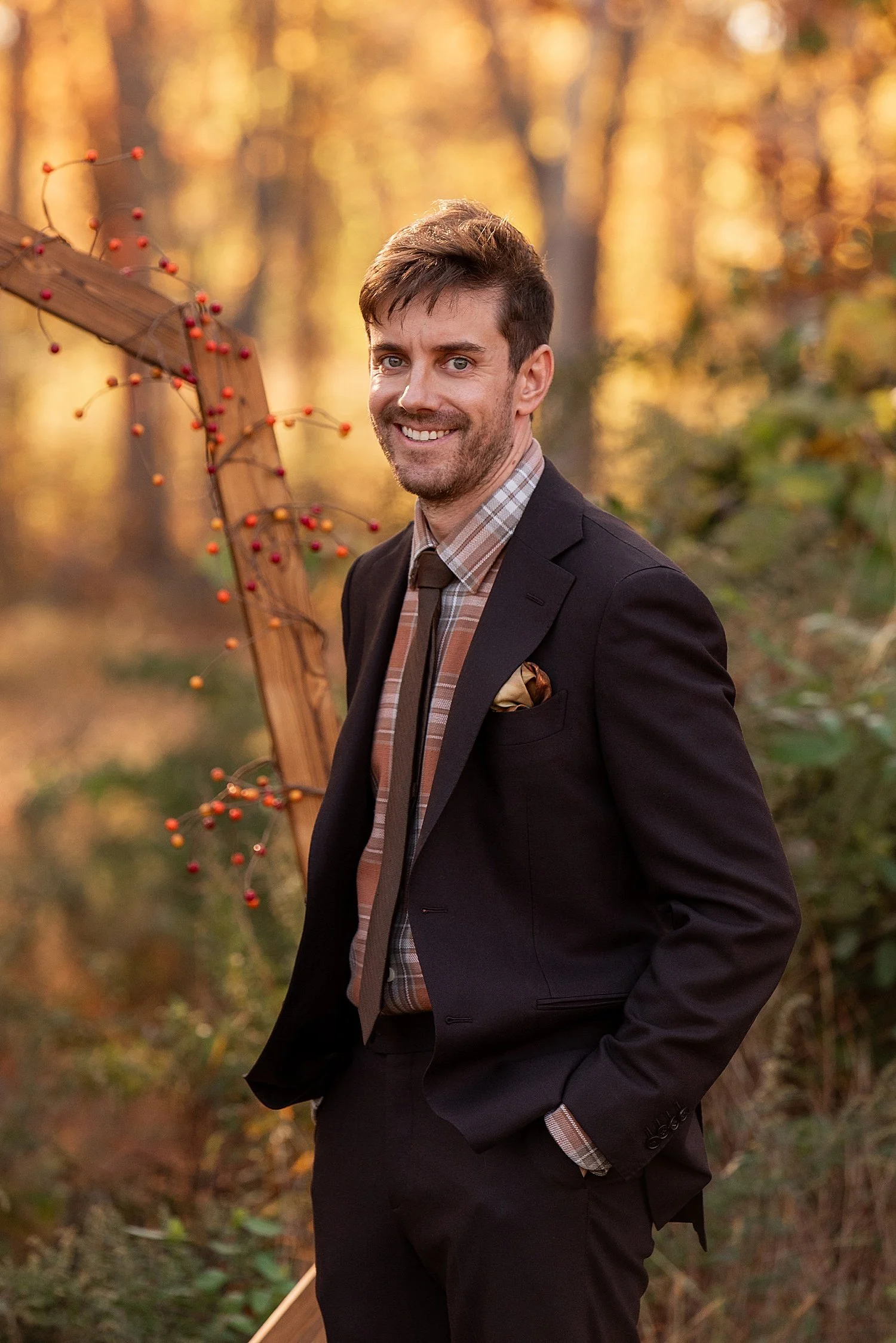groom in brown suit smiling as bride walks down isle of inmate wedding ceremony