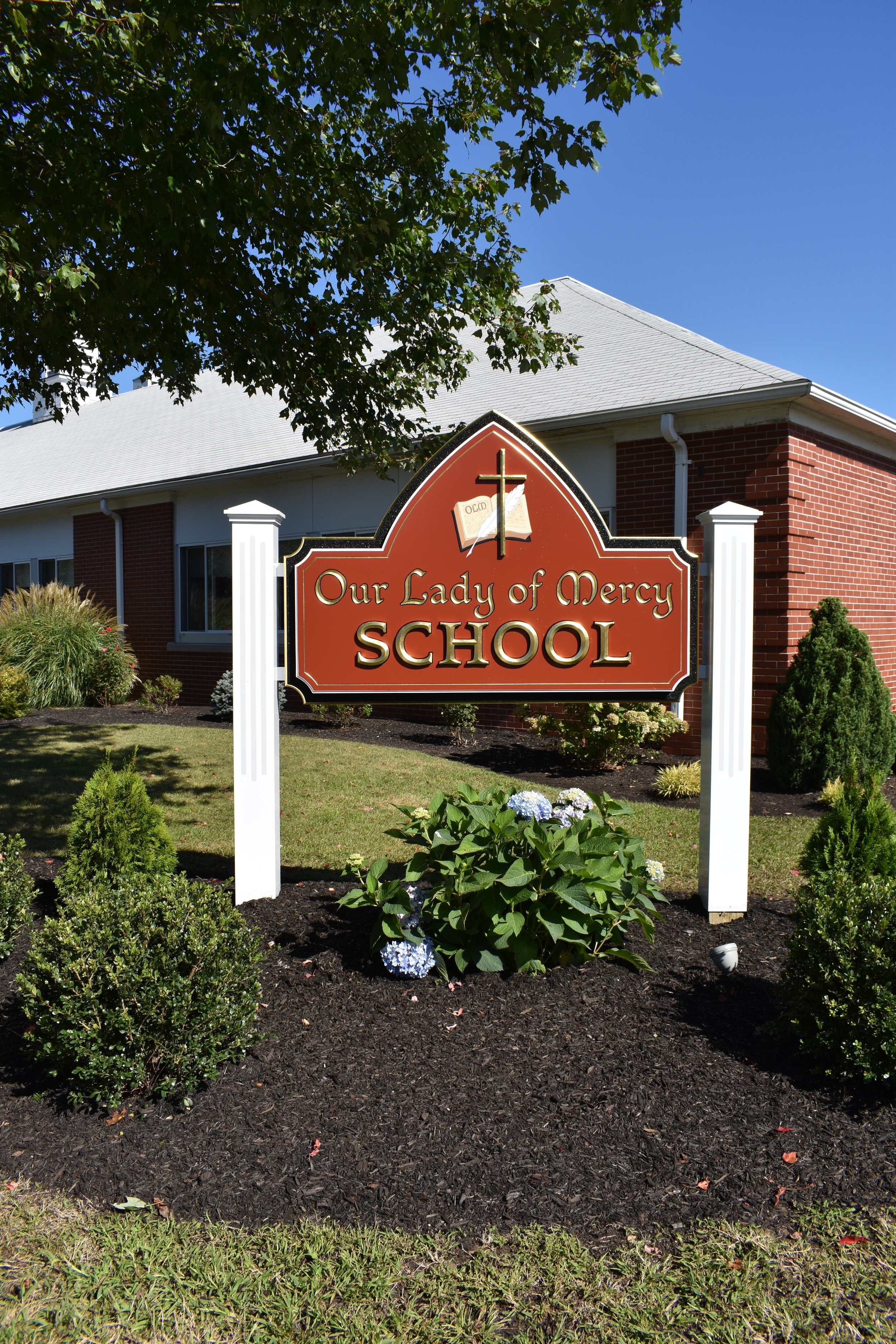 Bishop Evans Celebrates Opening Mass of the School Year,  Sister Jeanne and Sister Lourdes Annivesaries and Blesses New School Sign