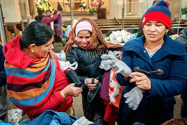 Refugees recieving assistance from Catholic Church.