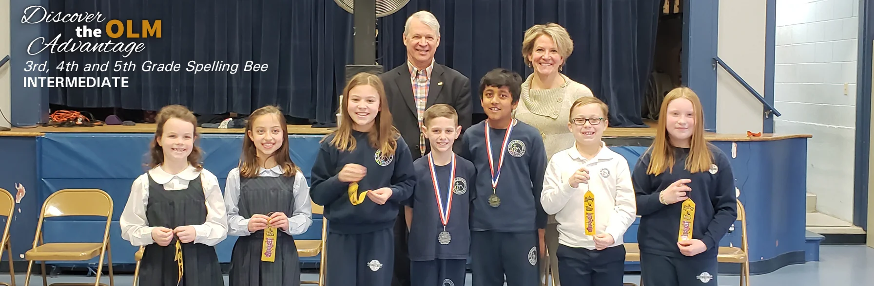 Mr. Fuller poses with students and faculty at the Annual Spelling Bee