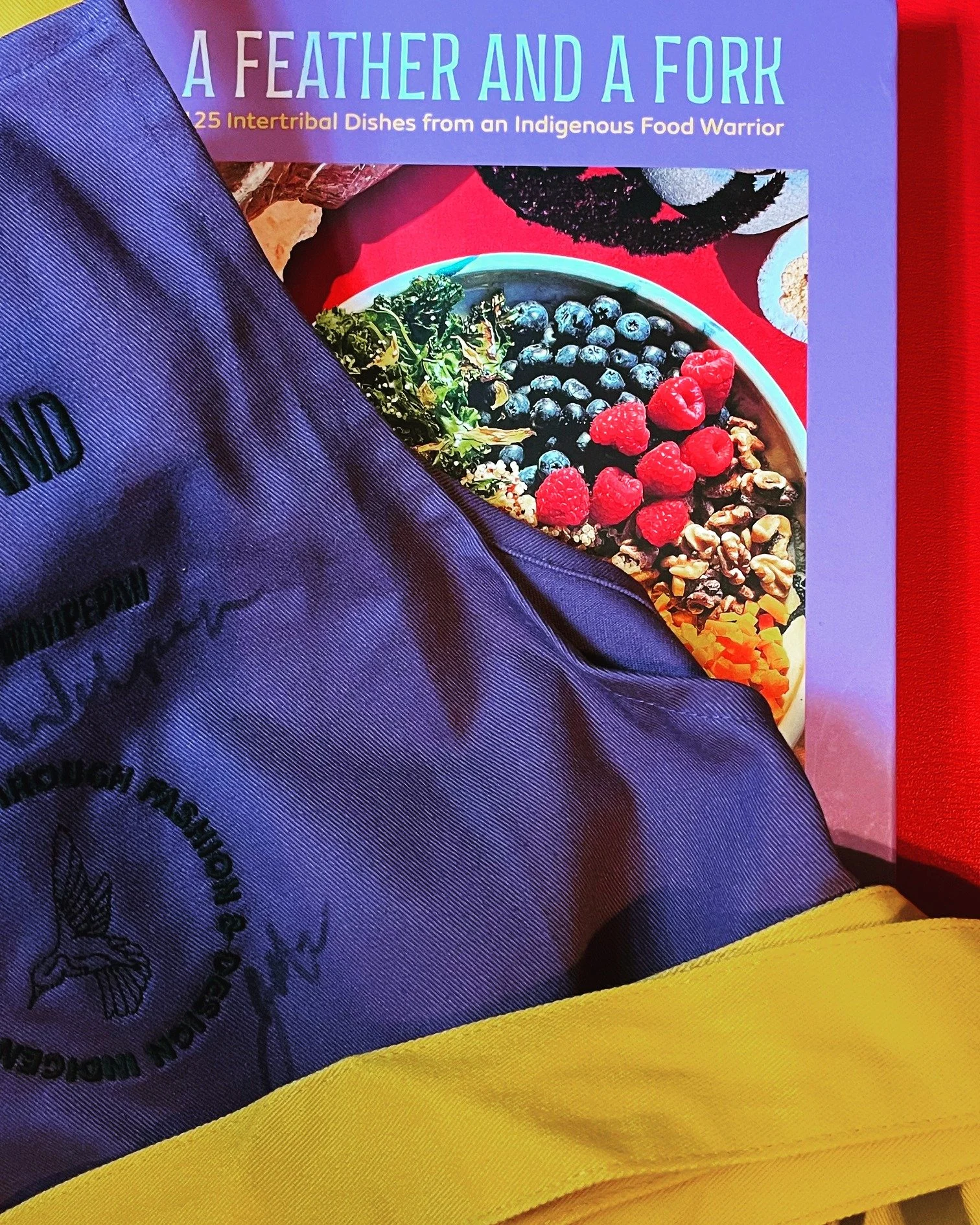 A special collaboration happened during the roll out of "A Feather and a Fork" earlier this year. Multimedia artist and fashion designer Joey Montoya of Urban Native Era created a limited apron inspired by the book cover--the purple that re