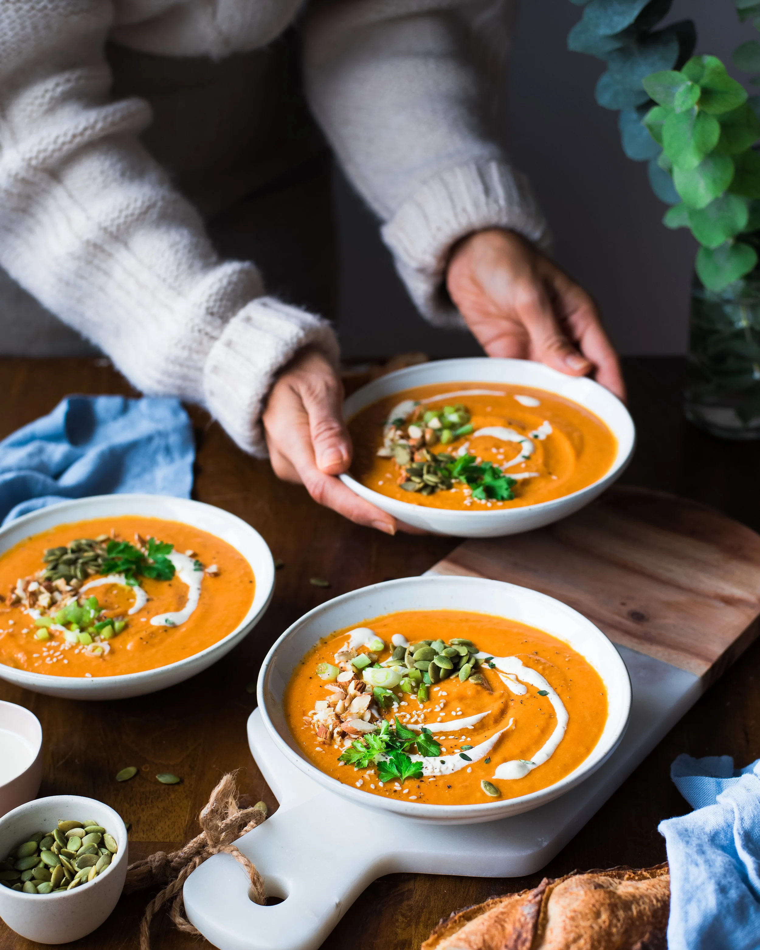 In this photo, the main subject is the front bowl of soup and the eye is naturally drawn to that point first. Using two other bowls of soup and diagonal lines helps guide the viewer’s eye throughout the frame. After the viewer sees the first bowl, her eye is drawn to the bowl to the back left, which then leads to the third bowl in my hands (which is the secondary subject in the photo).