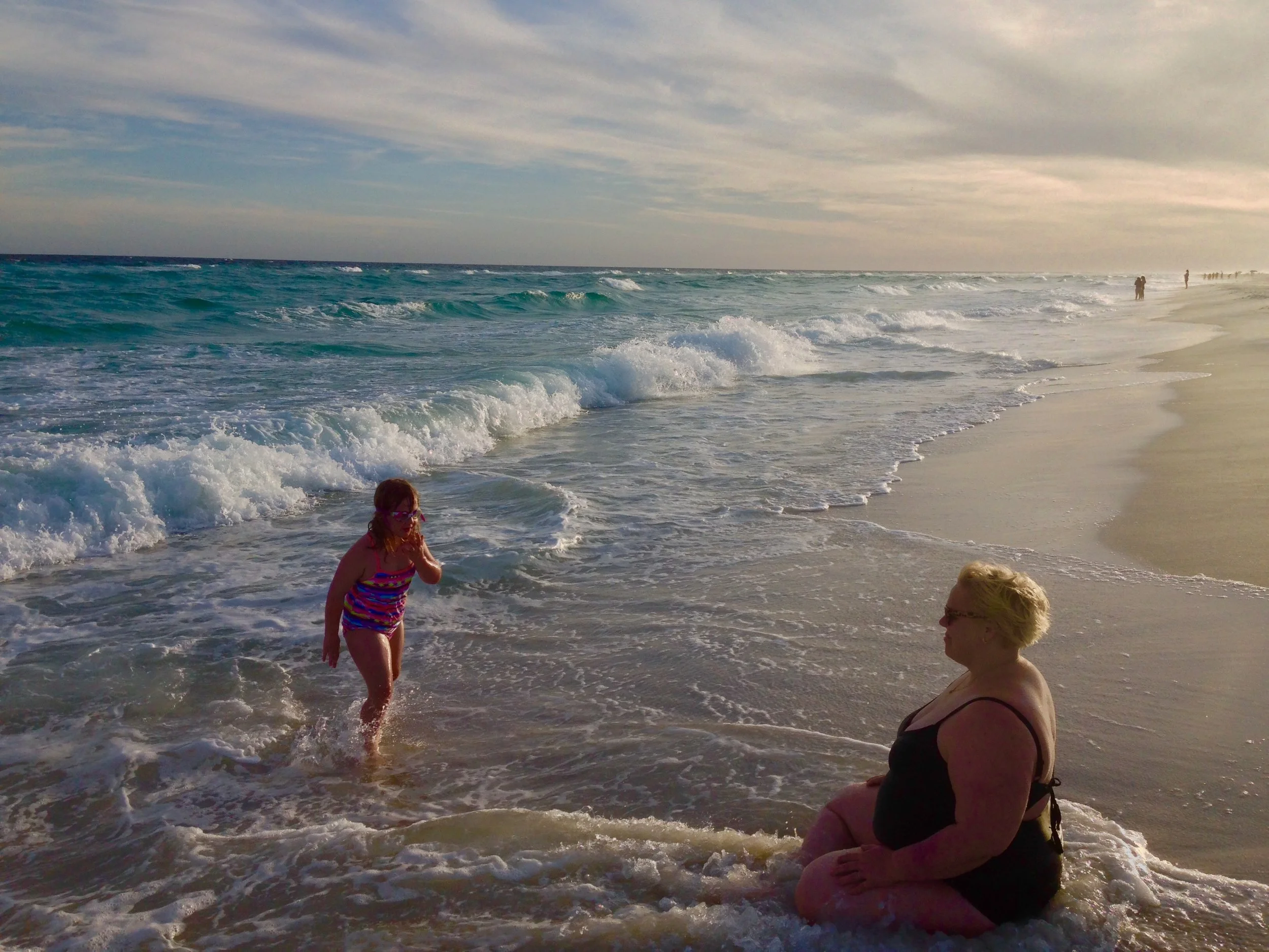 The sand is perfect, the water is perfect, the sky is perfect, the setting sun is perfect, the child is perfect, and the mother is perfect. All bodies are just as they should be. Let's get honest. It is more than a little scary to put a photo of myself in a bathing suit on the internet. I see women who can show their non-conforming bodies with casual courage and they try and call others out and let us know that its ok. I see you, I bow to you, I have deep gratitude to you and I am taking your leadership to heart. Every shred of information that I have obtained about female bodies in my early life stated that a person basically has no right to enjoy their body at my size. I shouldn't get to wear bathing suits, feel the sand and sun and water, I shouldn't move in a way that draws attention to my body. I have found a lot of peace through my yoga practice and counseling, and finding new and cool ways to employ my body, notice my strength and participate in the world. But I haven't found enough to not panic when I see a photo of myself. I want to say this out loud, because I think that there can be a lot of pretense in the discussion around body positivity. Yes our bodies are perfect and just right, but I have to assume that many many many of us fight hard to remember this on a daily basis. Whenever I feel that my body is wrong or that big is wrong. I think of elephants. I love elephants. The are huge, and sweet, and powerful and tender. They are perfect and beautiful. They harbor no shame. They traverse the earth with an unchallenged understanding that they belong. An elephant would not be surprised by herself in a mirror. She would have no expectations that she should be different. The way I apply my yoga practice to my body is that I allow myself to observe. I let the panic of imperfection arise. I practice non-attachment. I come back to my breath and stay there letting the panic dissipate in its own time. When the panic is gone, I am still there, my breath is still there and body is still there. Rinse and repeat.