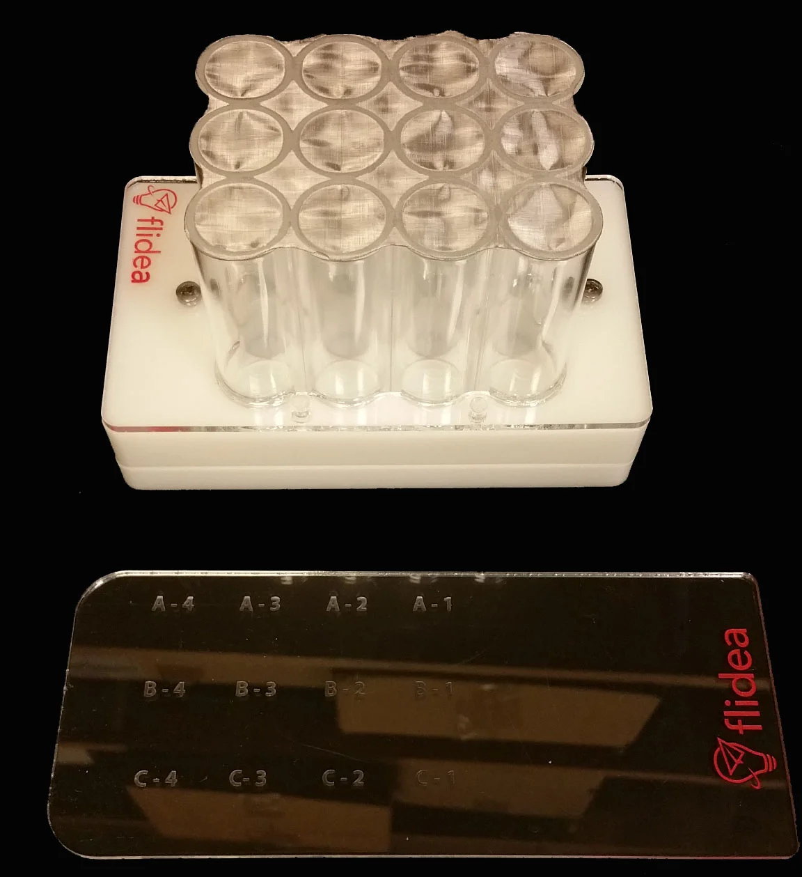 dFlat: A 12-well hotel for housing groups of flies. Using the hotel and slider system, you can transfer flies onto new foods in a matter of second and avoid taking time to individually flip conventional vials.