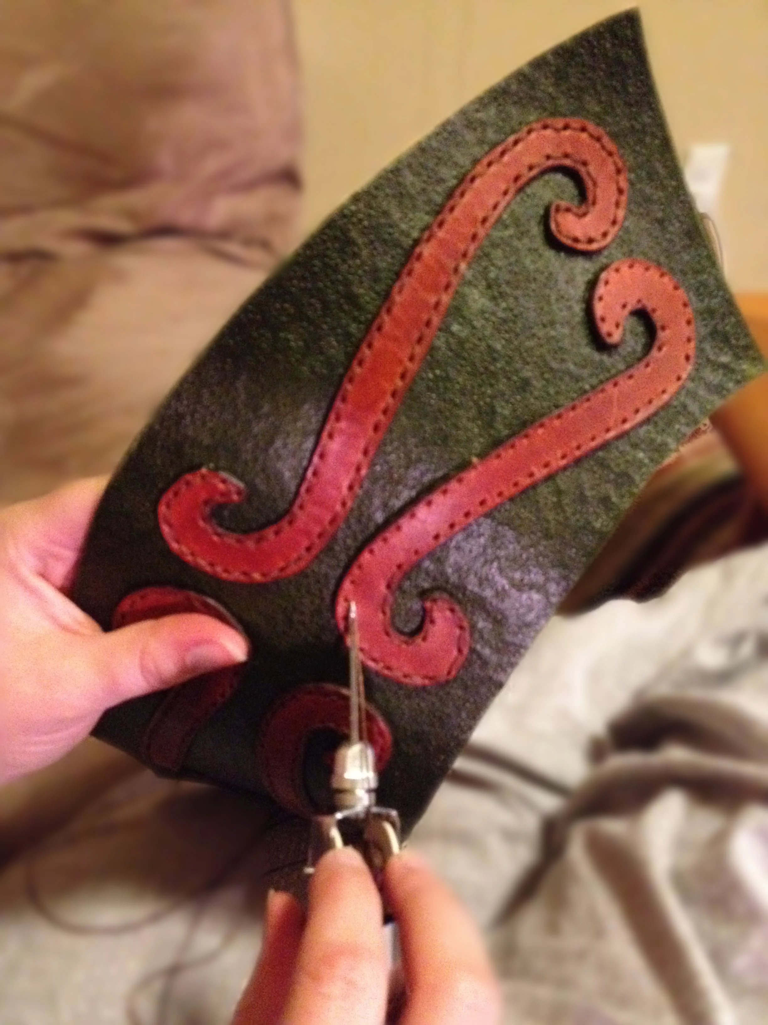  Handstitching pauldron appliques  